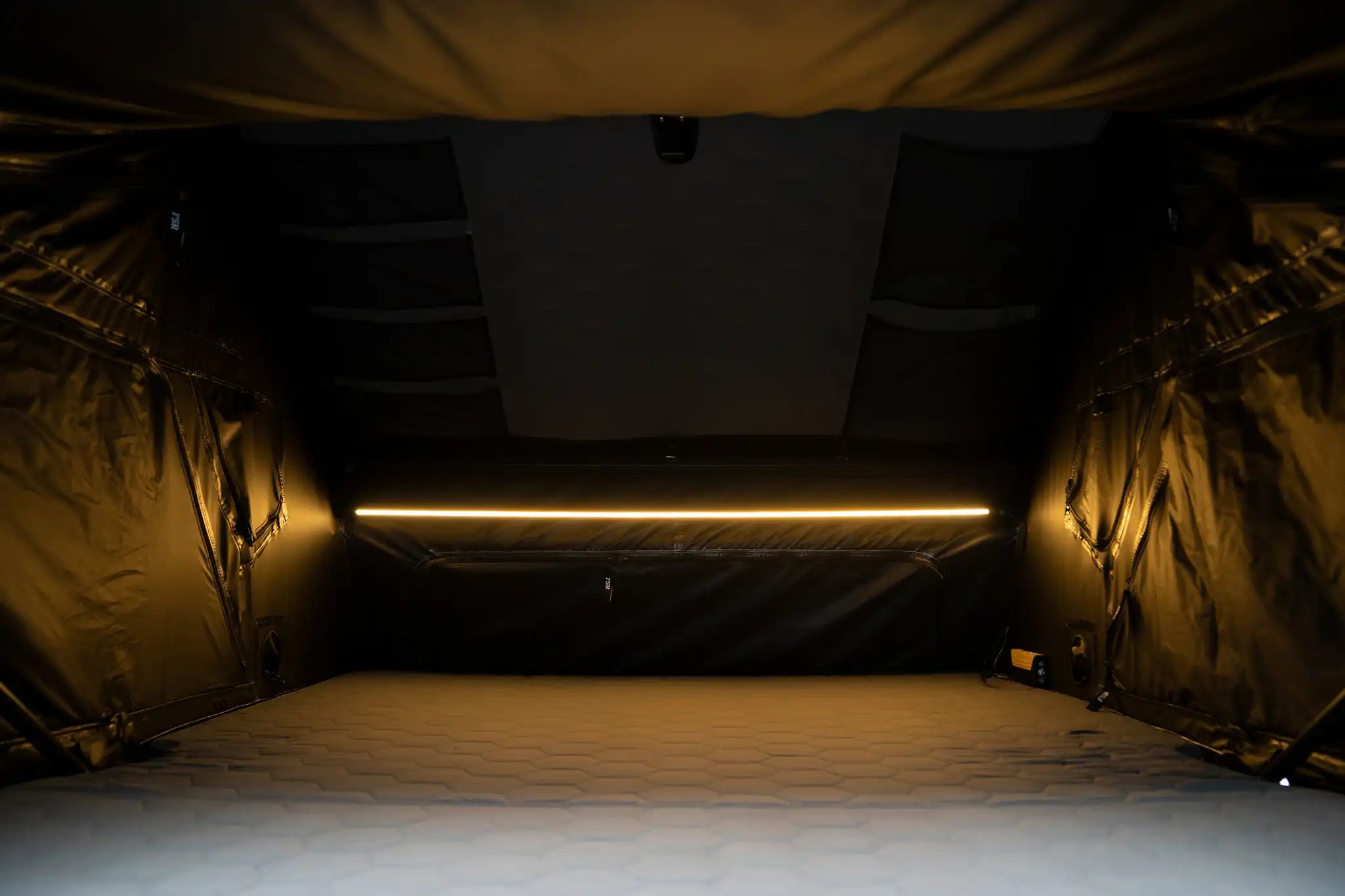 Interior view of the Freespirit Recreation Kali King rooftop tent showing sleeping area and built-in interior lighting.