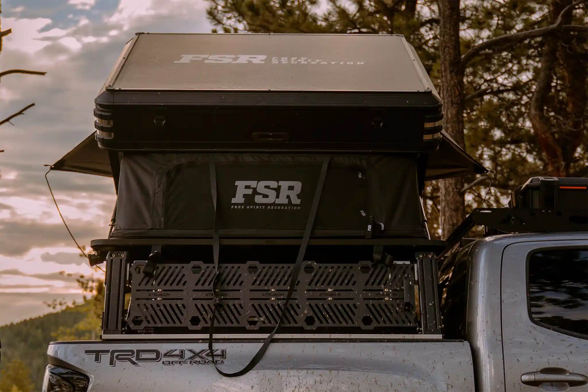 Freespirit Recreation Kali rooftop tent installed on a vehicle, featuring a sturdy fabric cover and side entry, ideal for outdoor camping.