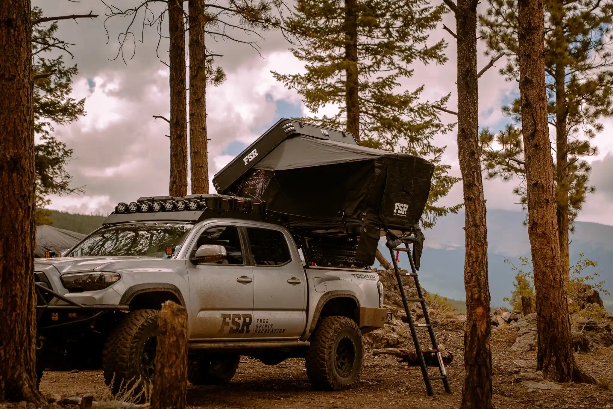 Freespirit Recreation Kali rooftop tent mounted on a Tacoma bed rack, ready for outdoor camping adventures.