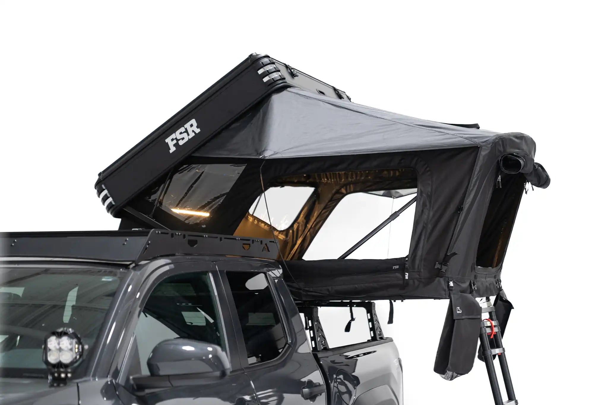 Freespirit Recreation Kali rooftop tent set up on a vehicle, showcasing its sturdy fabric and side view for outdoor camping adventures.