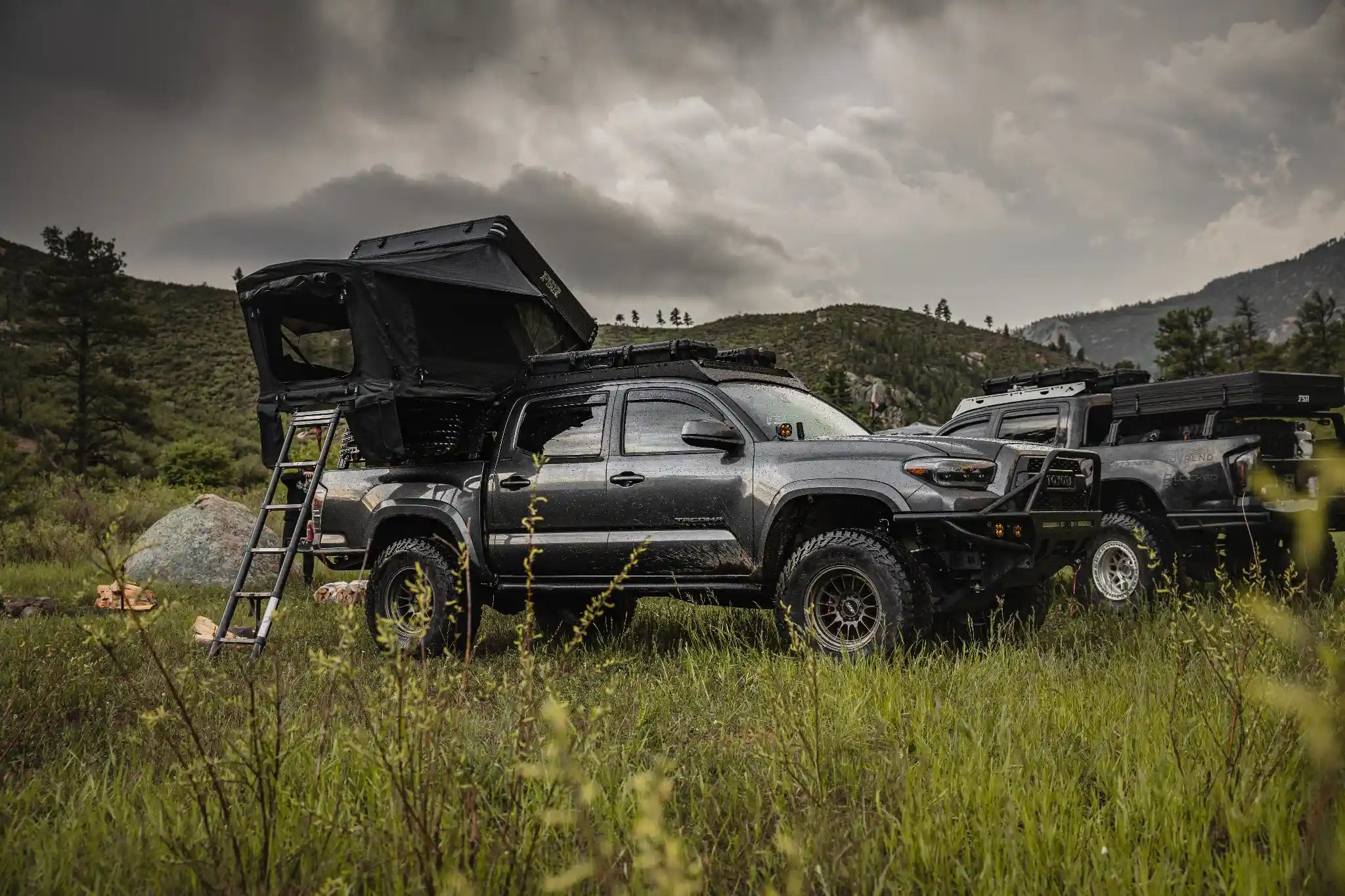 Freespirit Recreation Kali rooftop tent set up on a Toyota Tacoma in a mountain landscape, ready for outdoor camping adventures.
