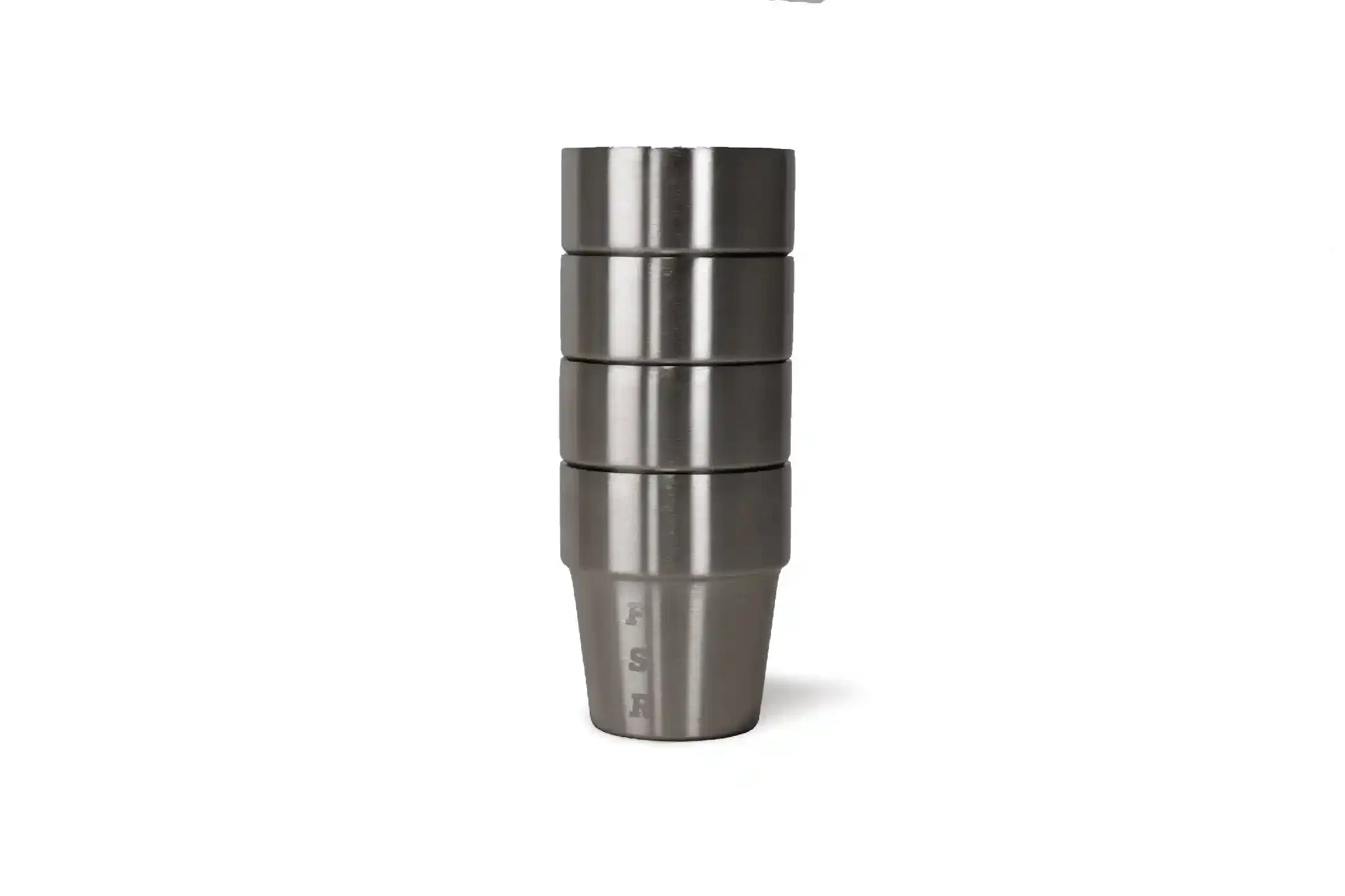 Set of four stainless steel whiskey cups from Freespirit Recreation, displayed on a kitchen countertop.