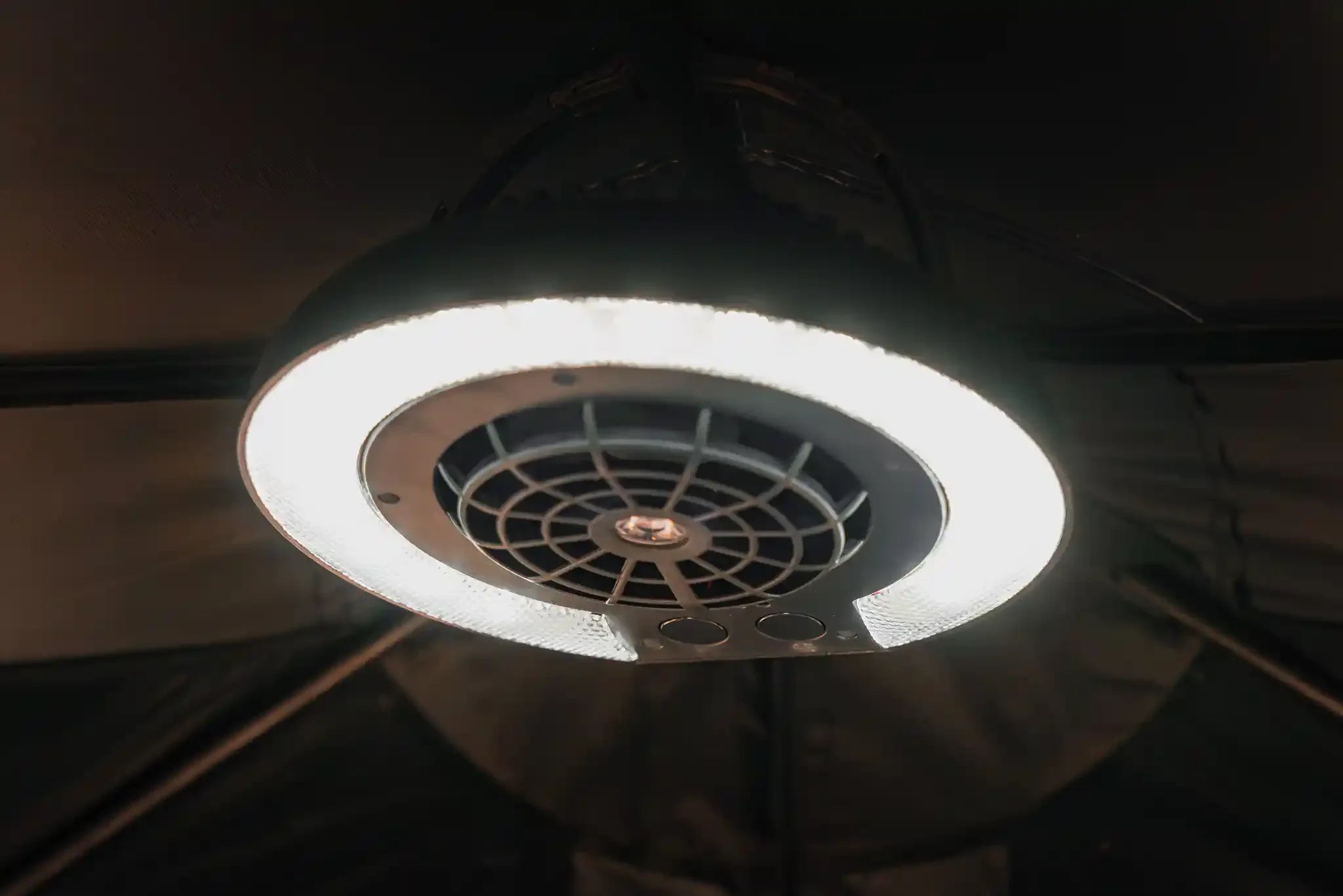 Freespirit Recreation LED Fan Lamp mounted inside a rooftop tent, providing bright lighting and ventilation for outdoor camping.
