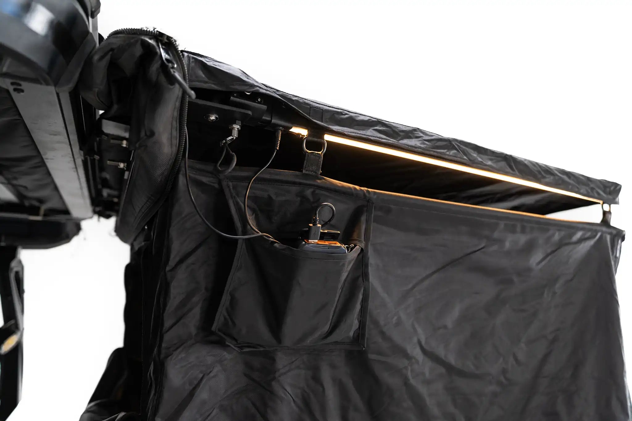 Freespirit Recreation shower awning lit up with battery pack, showcasing its spacious design and durable fabric in use.