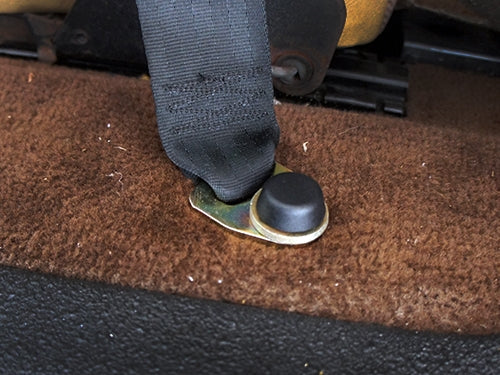 GoWesty bolt and cap replacement for front seat belt on 1980-91 Vanagon, showing the metal components for seat belt repair.