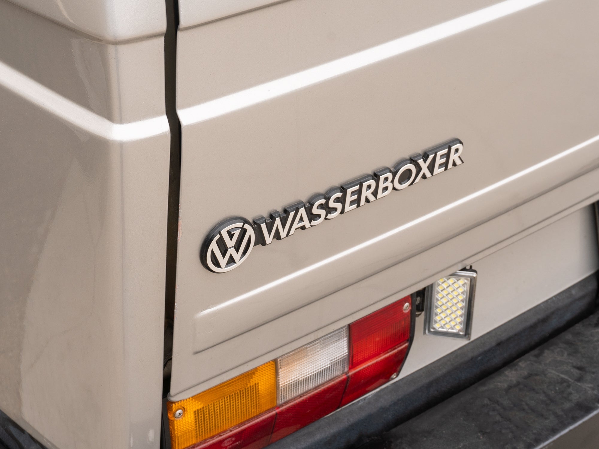 GoWesty Wasserboxer emblem featuring the brand logo, showcasing a detailed metal badge with black and silver design elements.