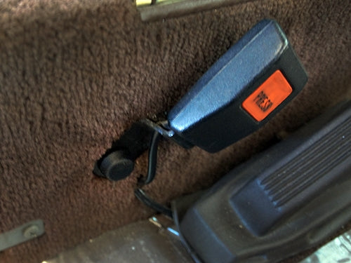 GoWesty bolt and cap replacement for front seat belt on 1980-91 Vanagon, showing the metal bolt and plastic cap in detail.