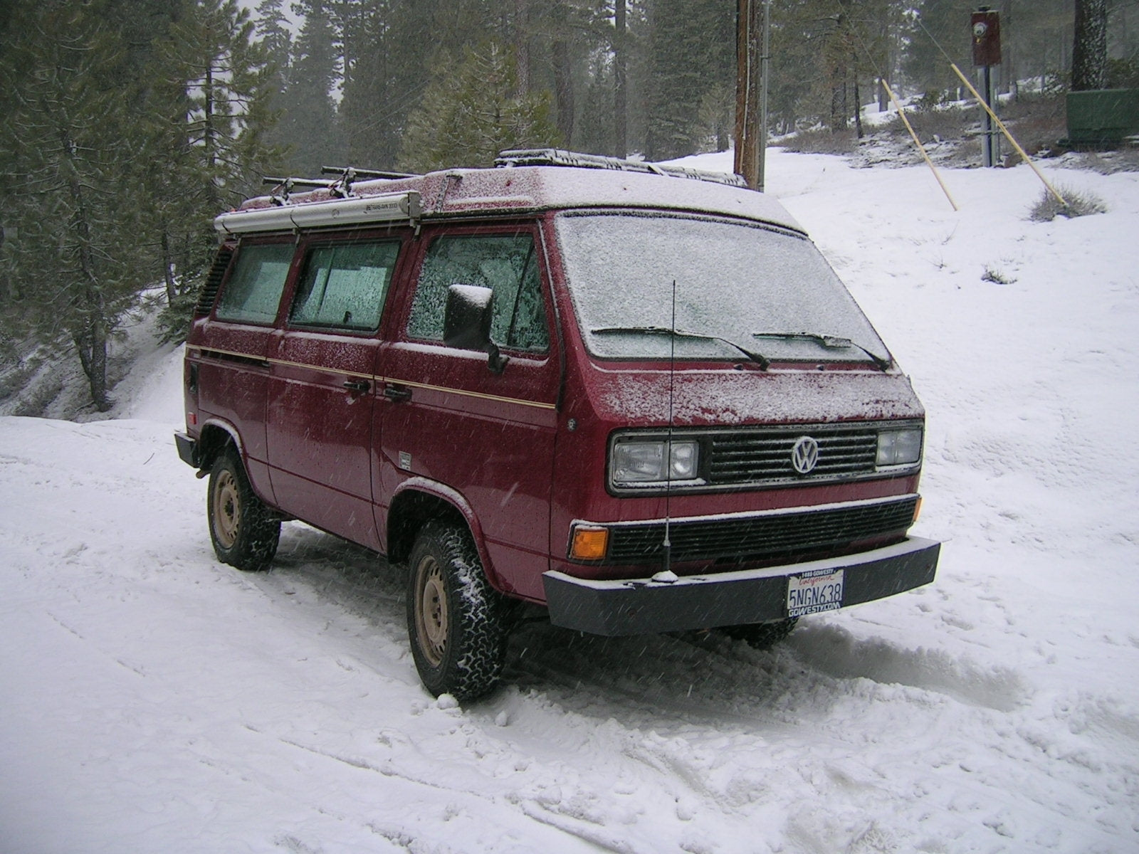 GoWesty locking strap securing luggage rack cargo box on vehicle exterior, durable outdoor accessory for travel safety.