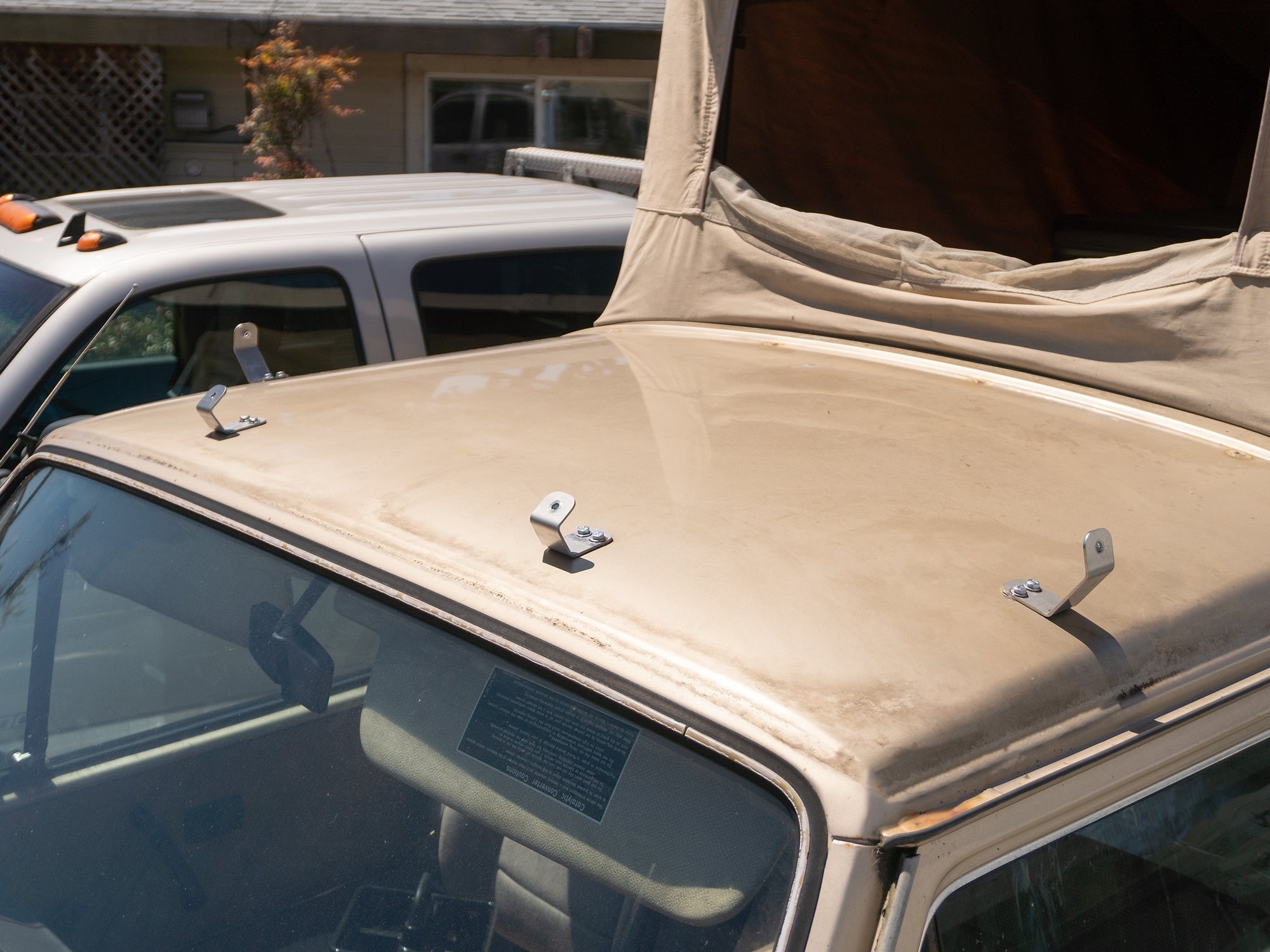 GoWesty Vanagon luggage rack bracket kit mounted on vehicle, showing metal brackets and hardware for roof rack installation.
