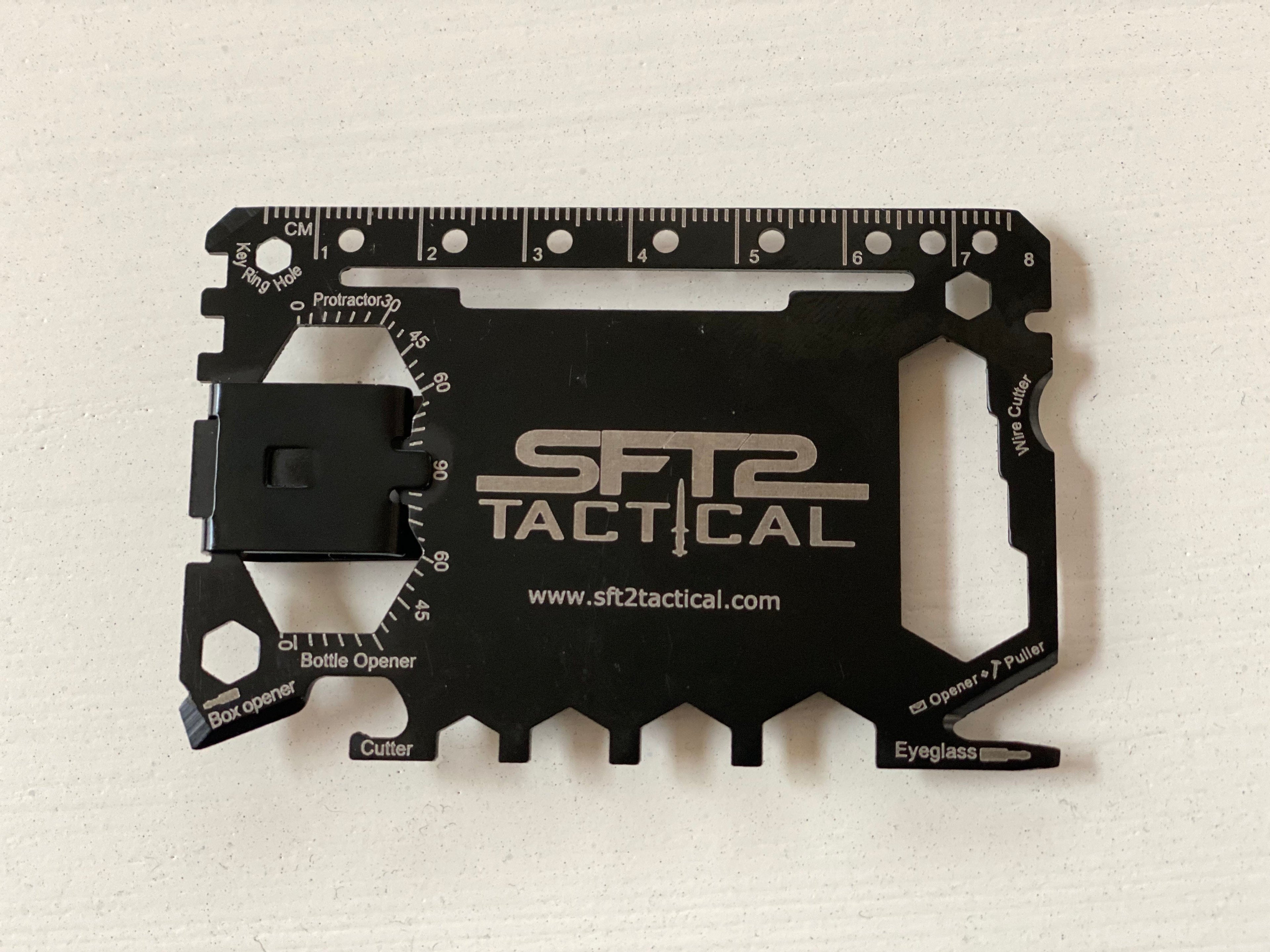 SFT2 Tactical credit card survival tool featuring multiple outdoor survival functions in a compact design.