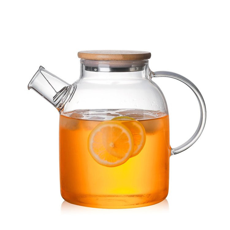 Clear glass teapot from Tea + Linen, 1800mL capacity, with a stainless steel infuser and elegant handle for brewing tea.