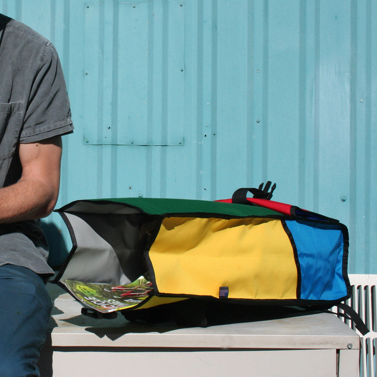 Green Guru Joyride Roll Top Backpack from ZEITBIKE in use, showcasing its durable design and roll-top closure for versatile carrying.