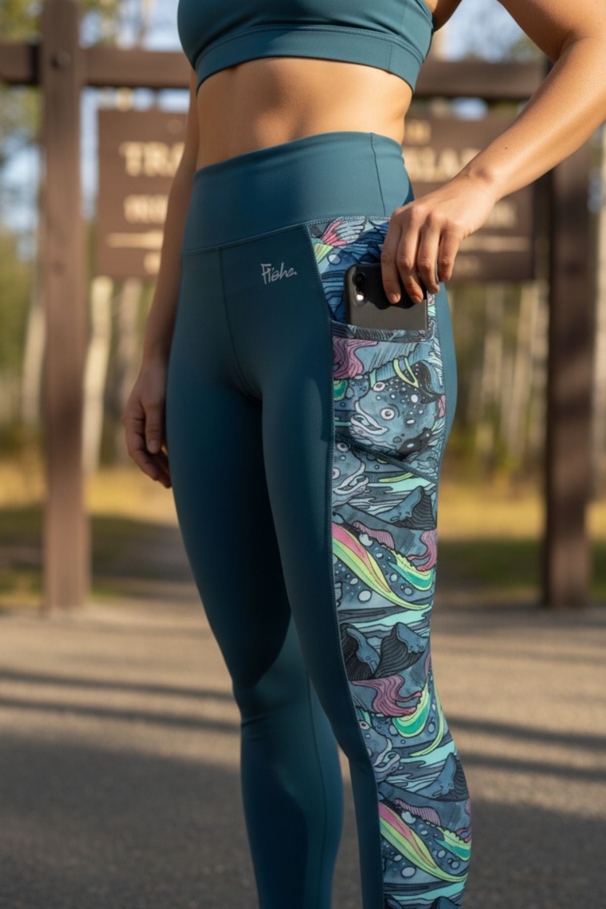 FisheWear HaliBorealis Pocket Leggings featuring a colorful abstract pattern and side pockets, designed for comfort and style.