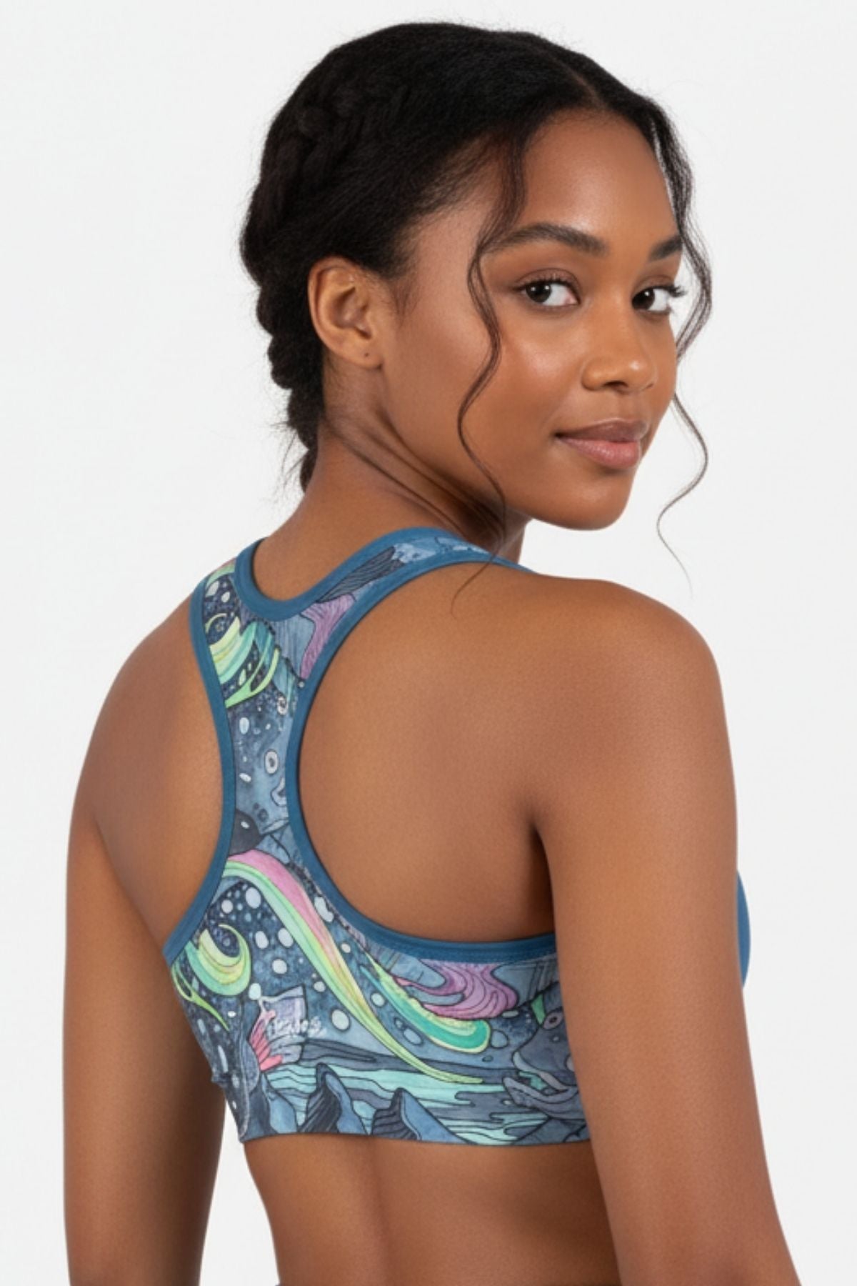 FisheWear HaliBorealis sports bra with supportive design and vibrant blue and green patterns, shown on a mannequin.