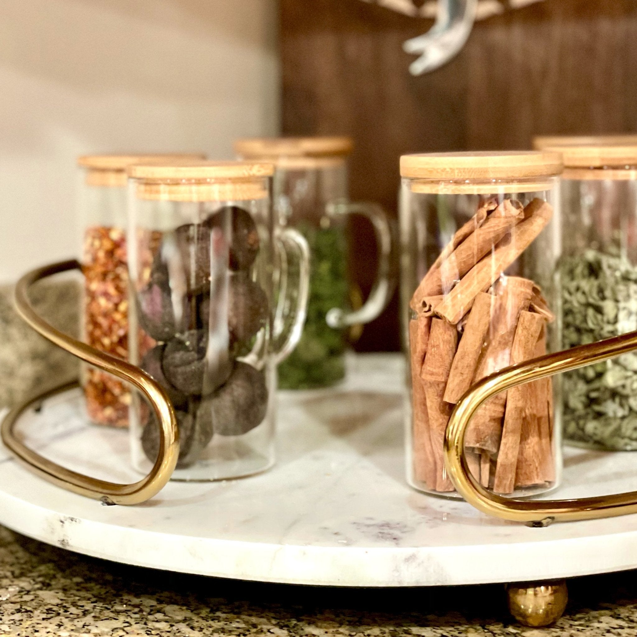 Set of hand-blown glass pitcher and cups with bamboo accents by Tea + Linen, showcasing elegant, artisanal drinkware.