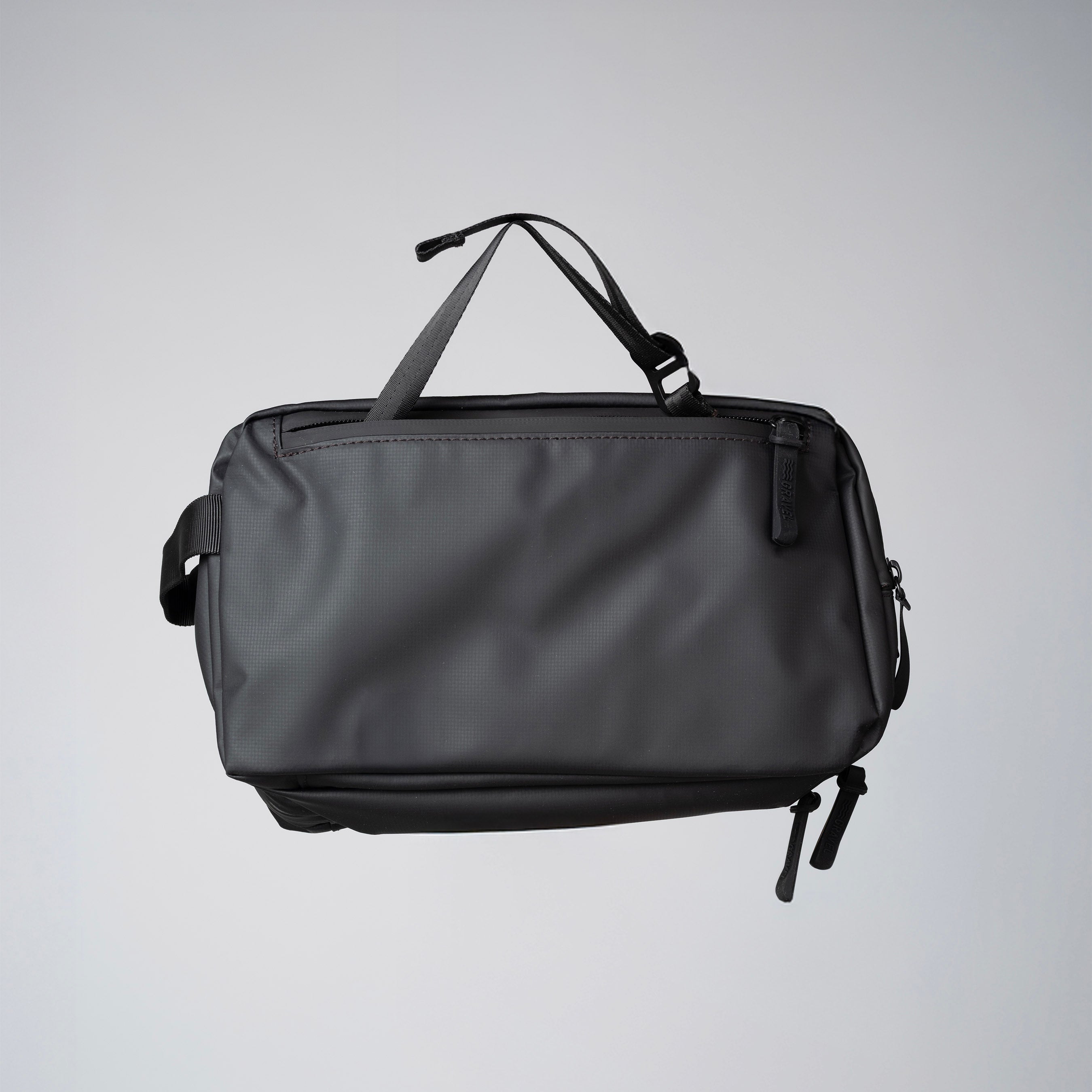 Gravel Max™ Toiletry Bag hanging with strap, compact travel storage for toiletries and personal care items.