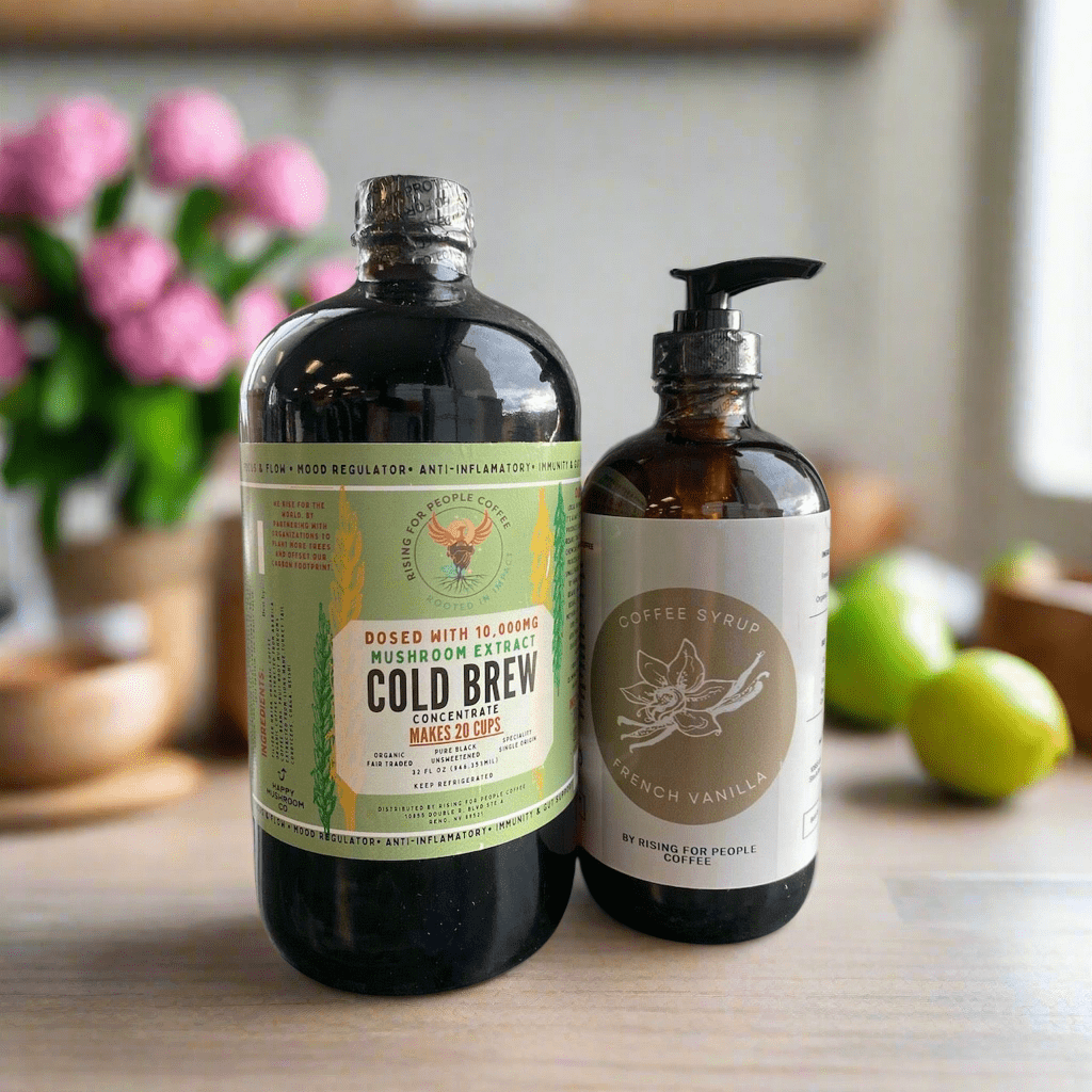 Happy Mushroom Cold Brew and French Vanilla Coffee Syrup by Rising For People Coffee Co. in a clear glass bottle with label.