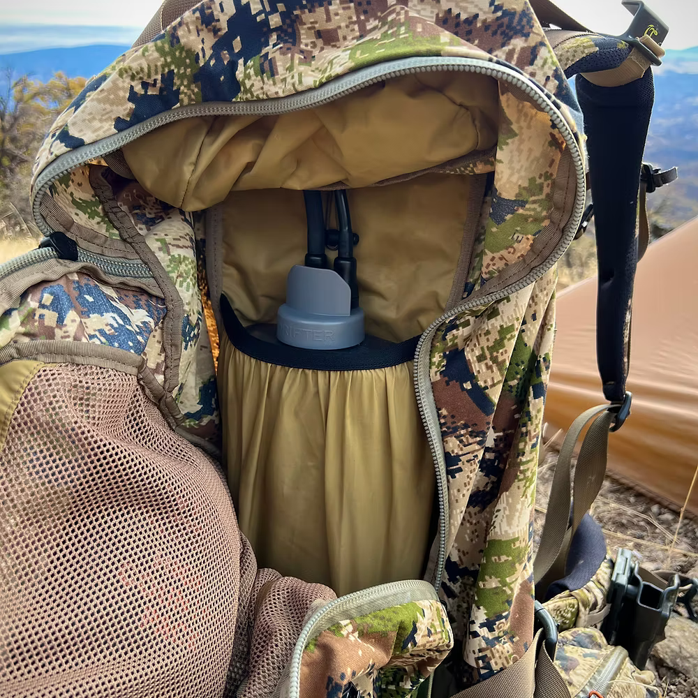 Drifter Hydration Lite Hydration System with hard bladder displayed inside a compact backpack for outdoor activities.