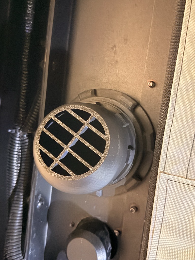 Muddy River Outdoors diesel heater port installed on a camper, showcasing the pass-through design for efficient heating.