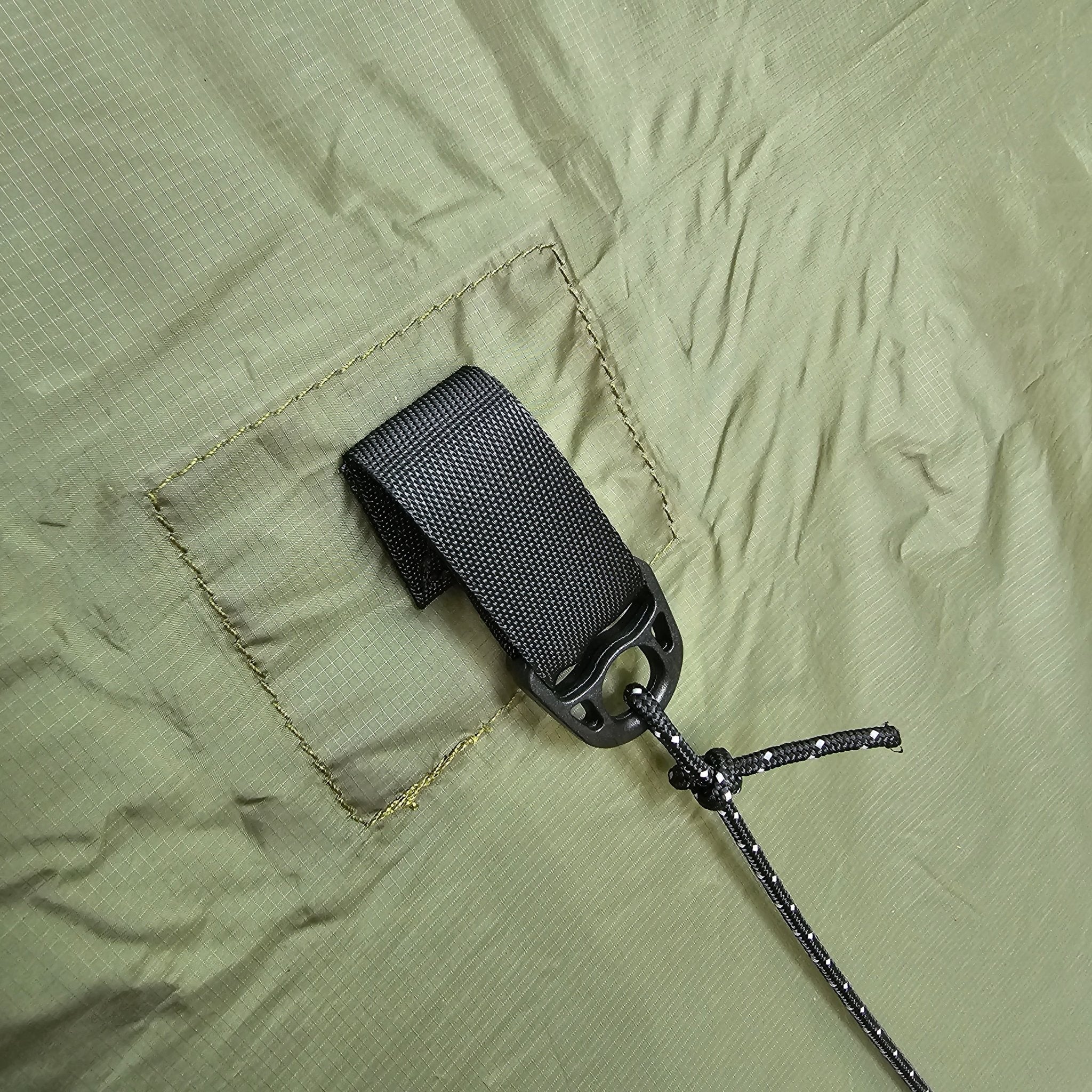 Hanging High Hammocks Hideaway Tarp, a 12-foot rain tarp for hammock camping, with waterproof material and sturdy attachment points.