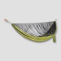 COCOON ultralight mosquito net hammock hanging outdoors, showcasing its lightweight breathable mesh and compact design.