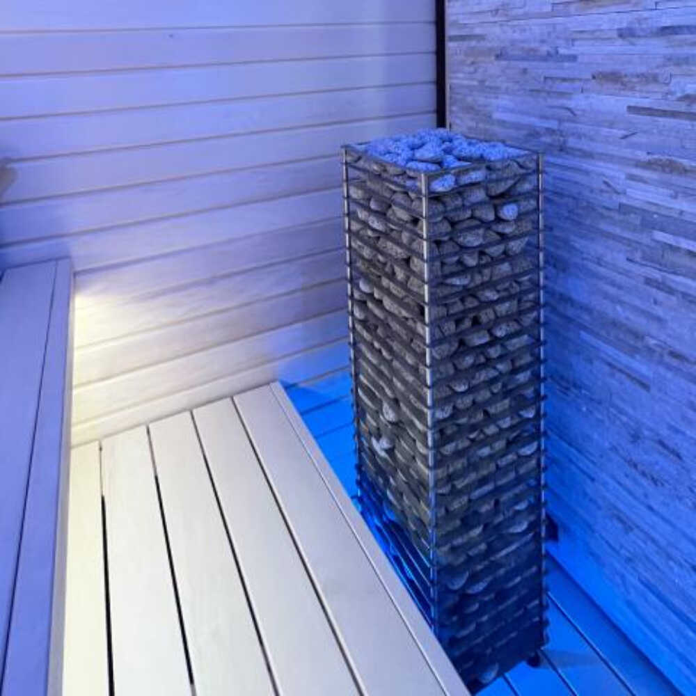 SAKSBY WHOLESALE Huum Cliff Slim electric stainless steel sauna heater with digital controller and sauna stones, blue light display.