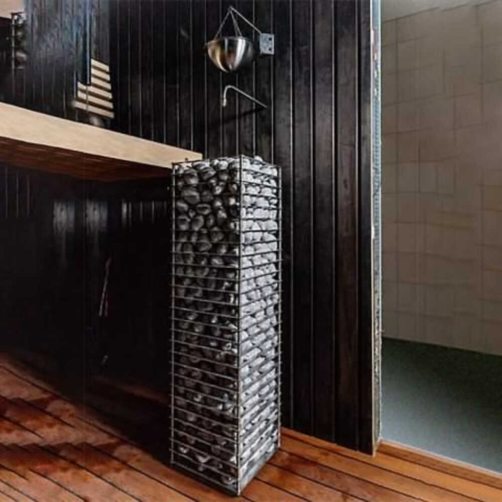 Stainless steel Huum Cliff Slim electric sauna heater with digital controller and sauna stones, front-left view.