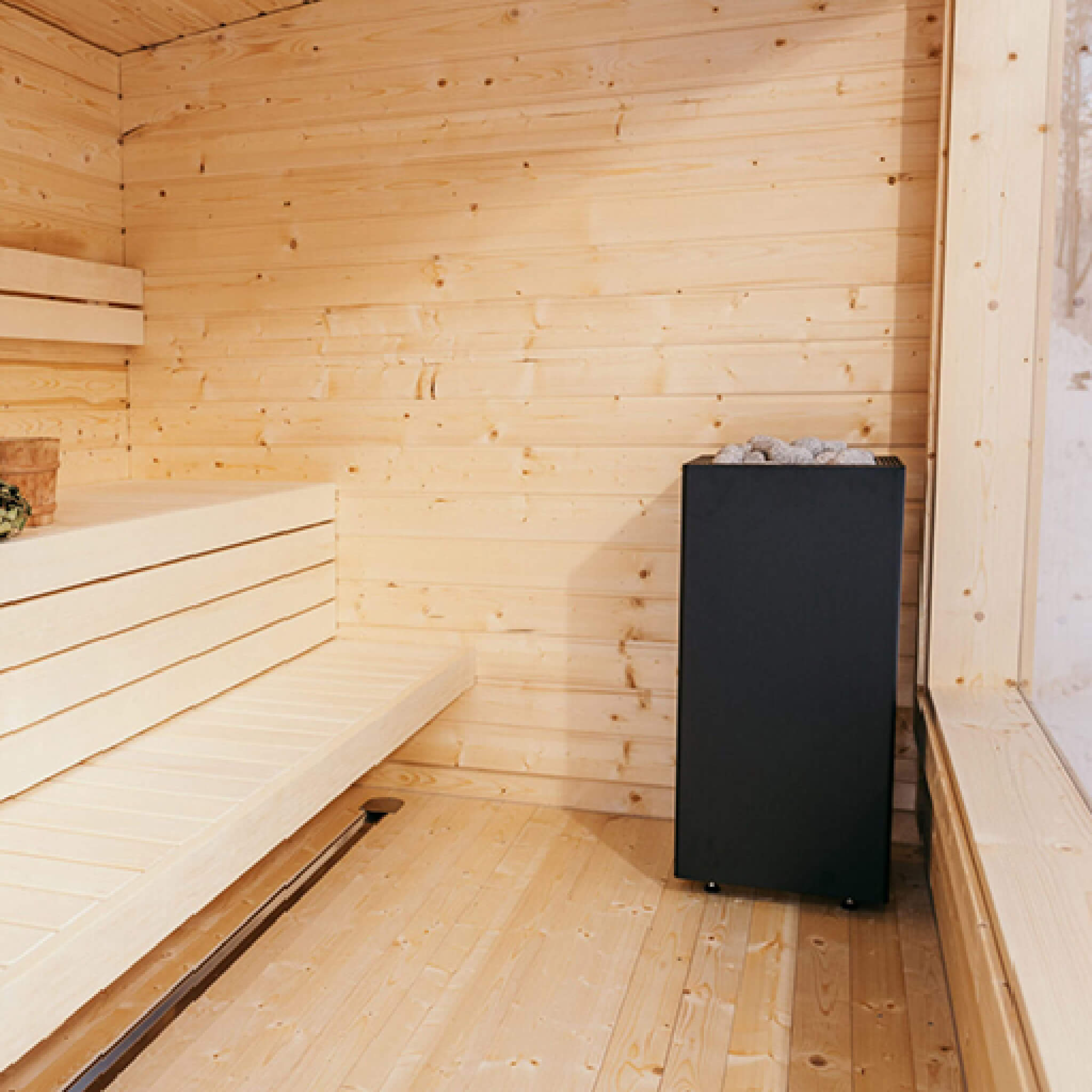 Huum Core Black sauna heater with UKU digital controller and stones, featuring adjustable legs, by SAKSBY WHOLESALE.