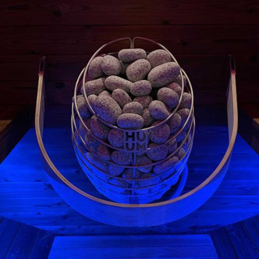 Huum Drop 240V SGS Listed wall mount sauna heater with blue light display, digital controller, and sauna stones, wall-mounted design