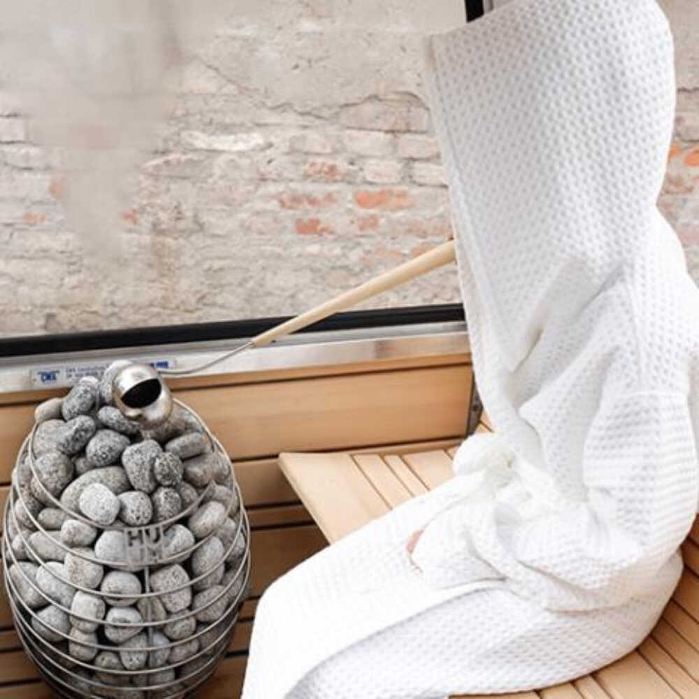 SAKSBY WHOLESALE Huum Drop 240V SGS-listed wall mount sauna heater with digital controller, water-drop design, and visible sauna stones.