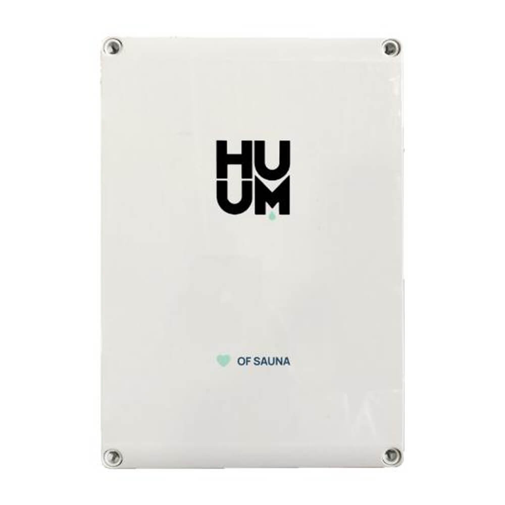 Huum Hive Premium 18kW floor-mounted sauna heater with UKU control, extension box, and sauna stones in a modern sauna room.