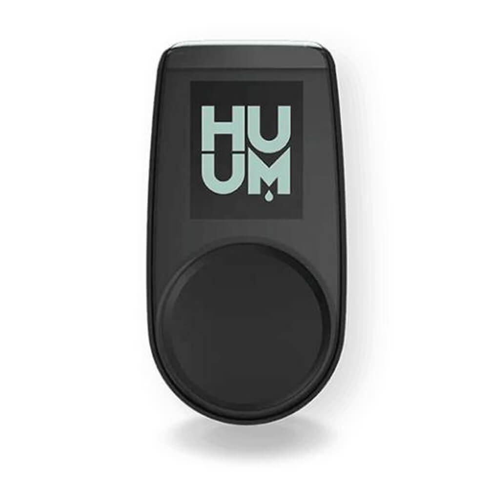 Huum Hive Premium Floor-Mounted Sauna Heater with UKU control, extension box, and sauna stones, in a modern indoor sauna setup.