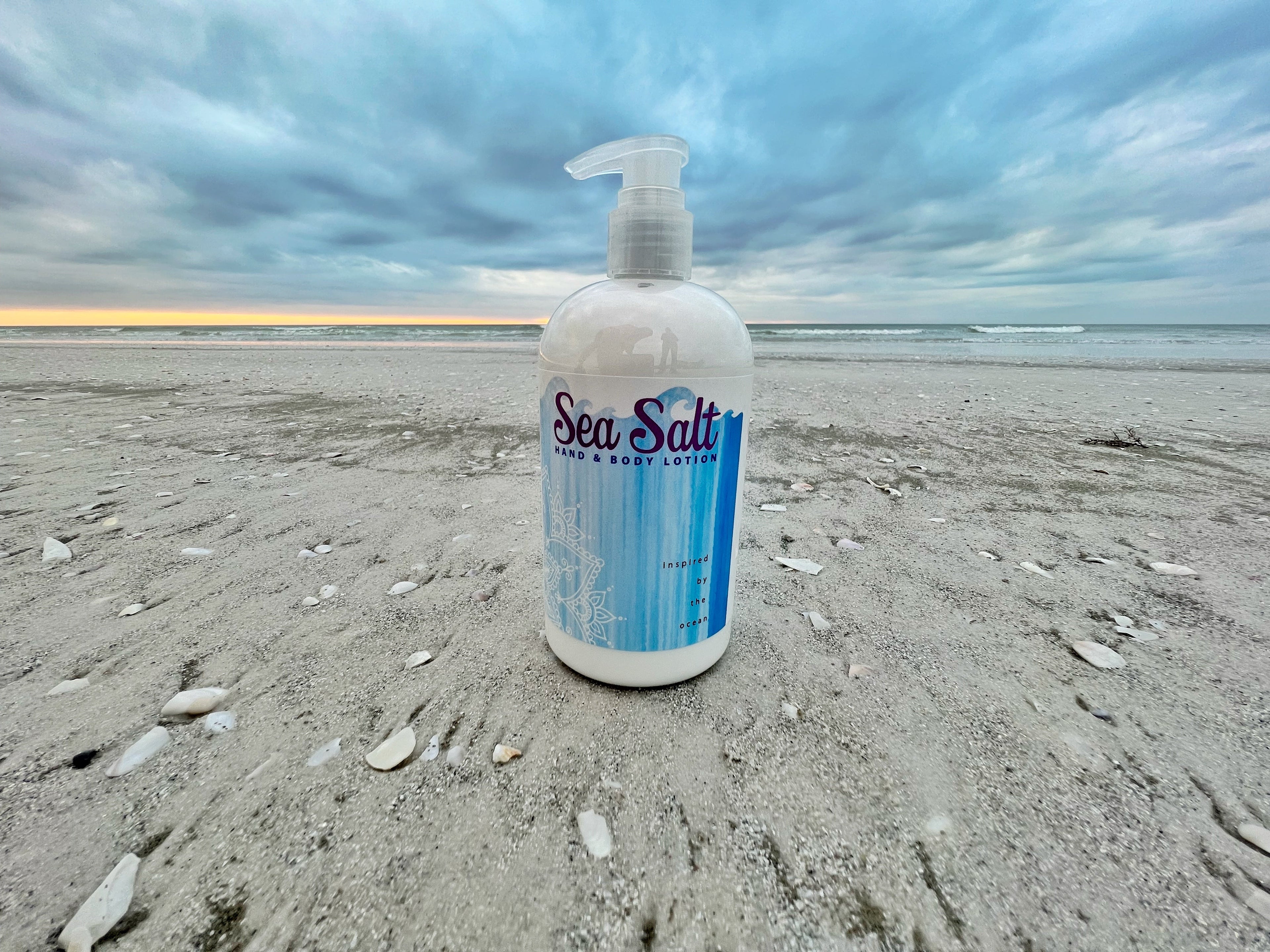 Essential Journeys sea salt hand and body lotion in a 16 oz jar, showing the creamy texture and salt-infused moisturizing formula.