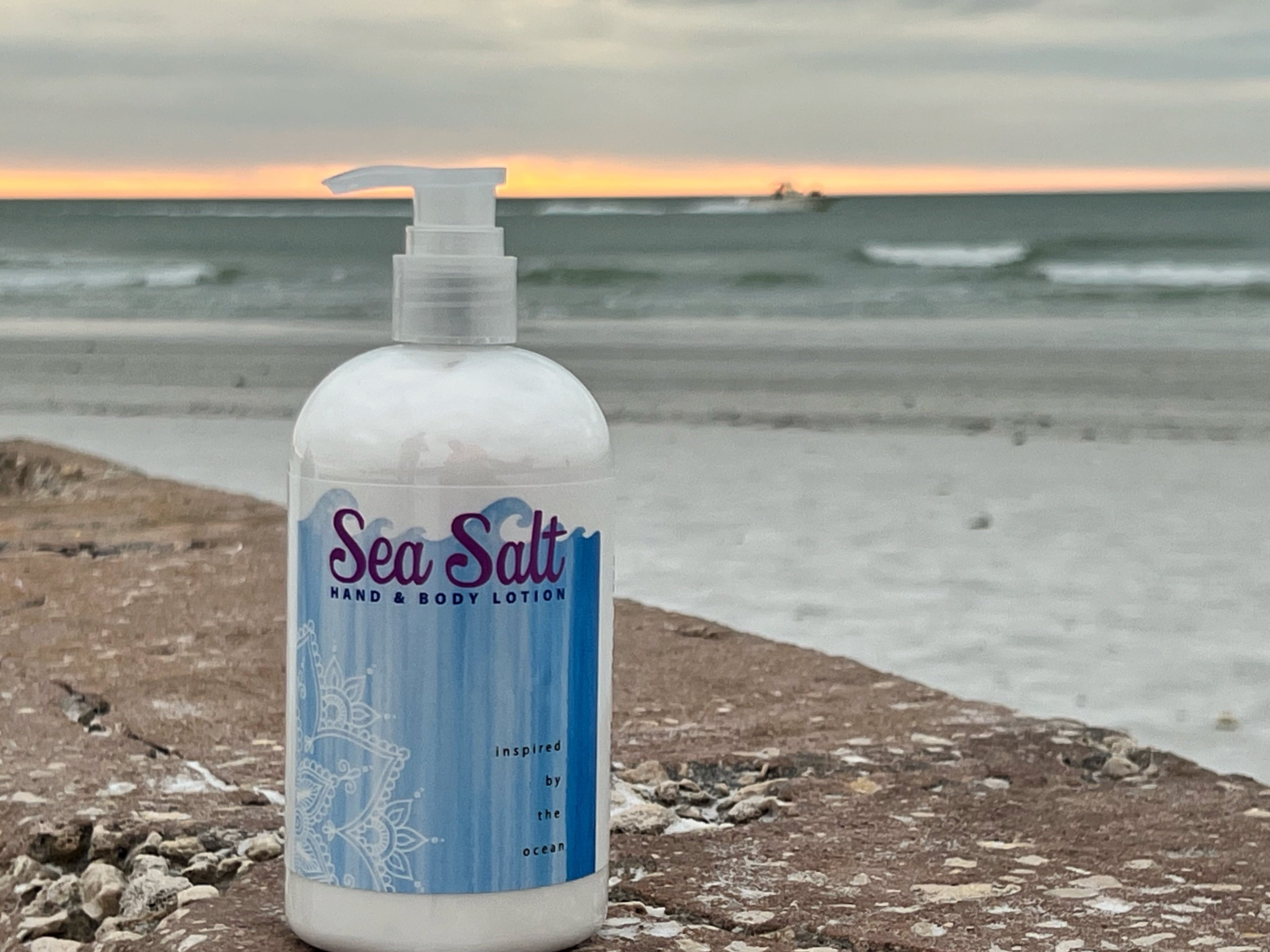 Essential Journeys sea salt hand and body lotion in a 16 oz or 2 oz jar, with a creamy texture and natural ingredients.