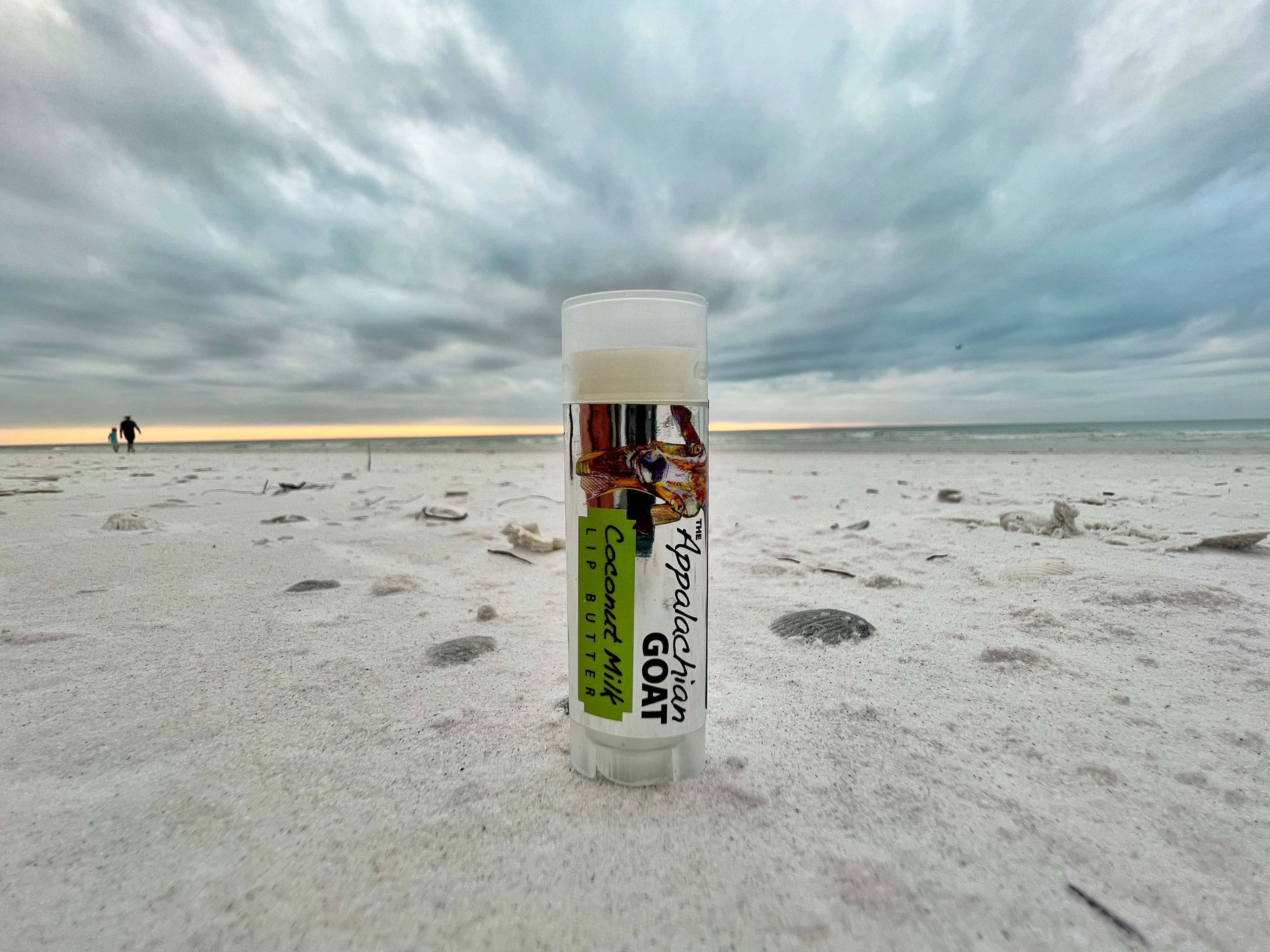 Coconut Milk Luxury Lip Butter by THE APPALACHIAN GOAT from Essential Journeys, creamy lip balm in a sleek container.