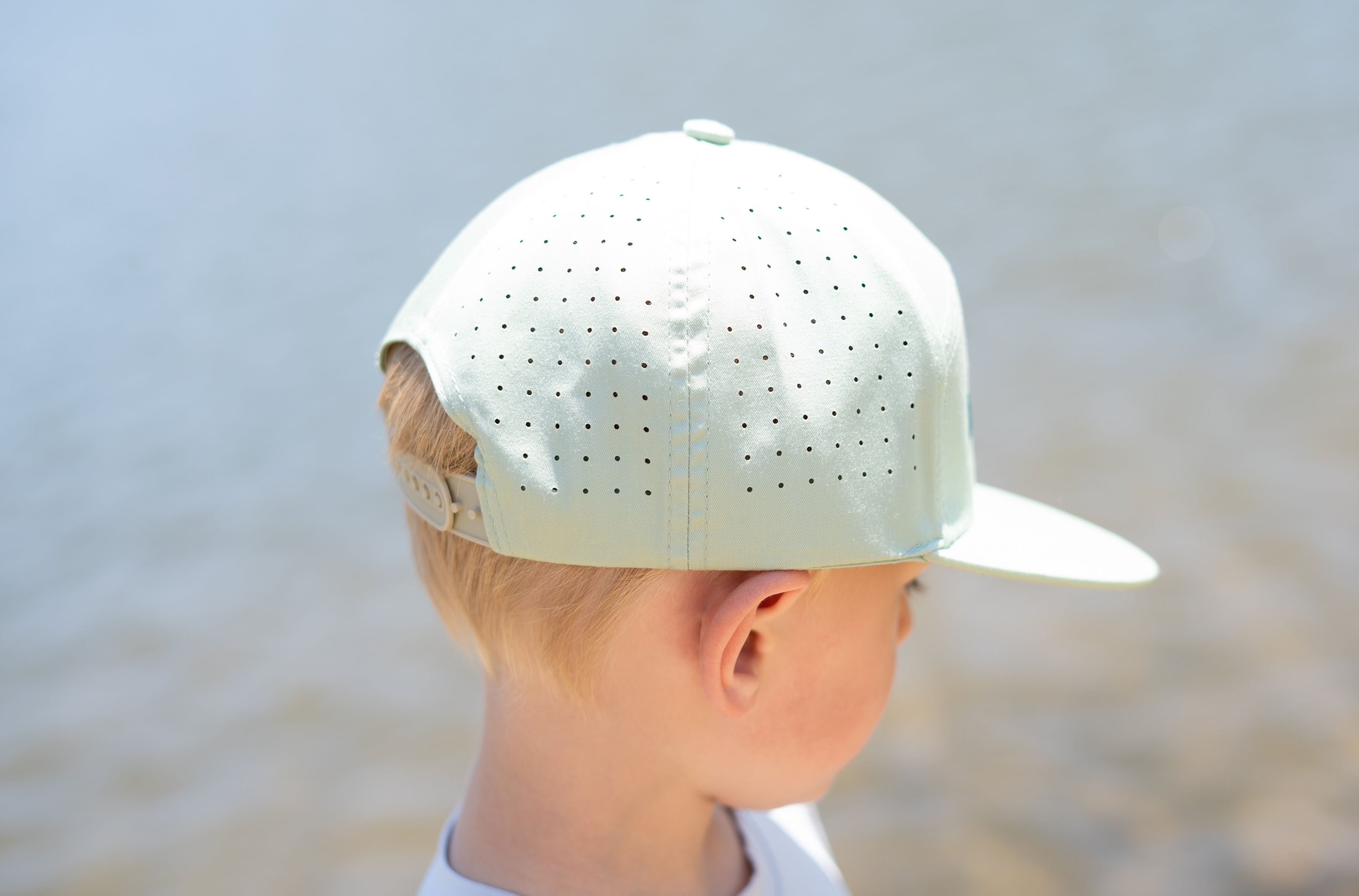 Keep the Littles Wild The Catch snapback hat with embroidered design, featuring a flat brim and adjustable strap.