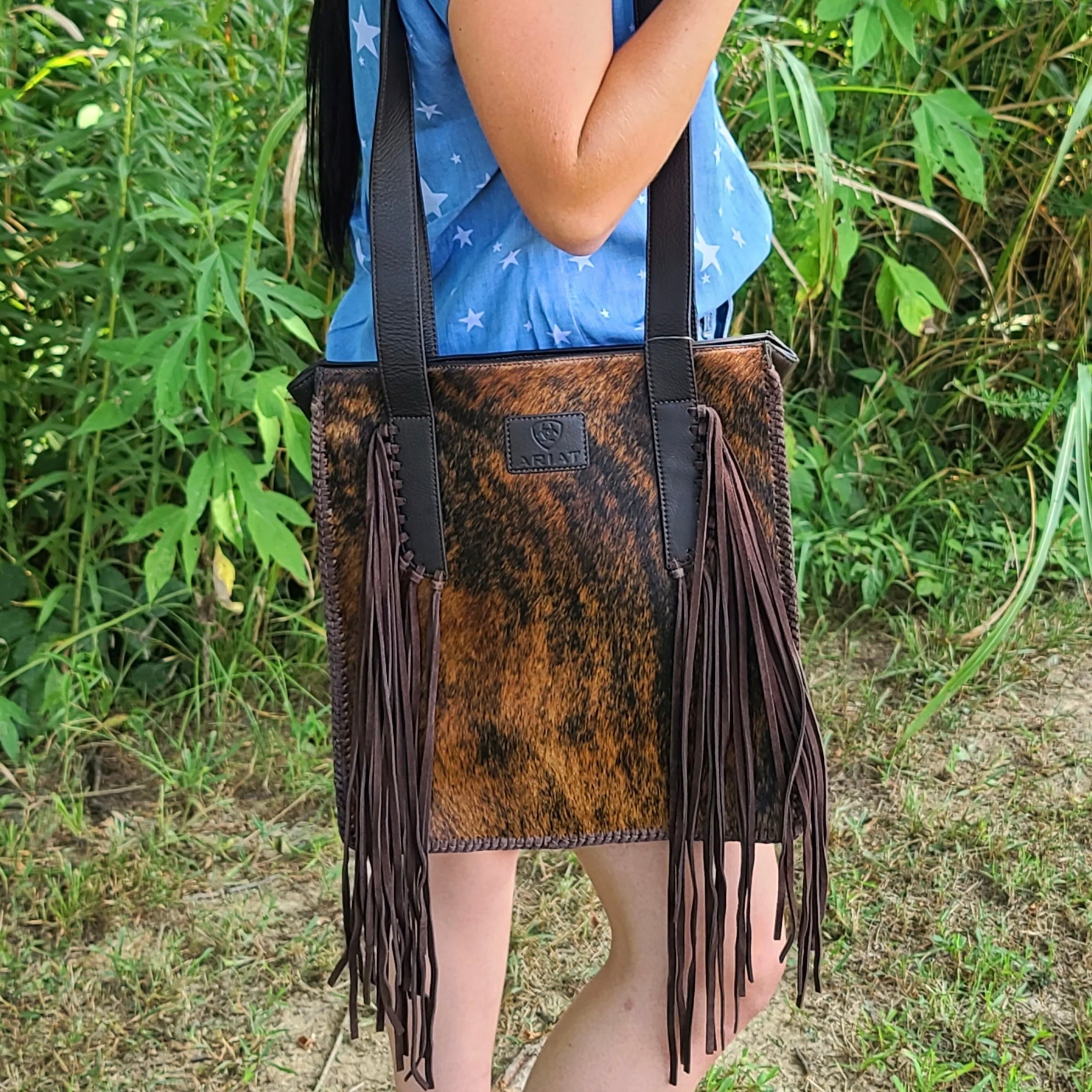 Scarlett Calf Hair Tote by Ariat, stylish wallet with brown and black calf hair design, featuring multiple card slots and a zipper closure.