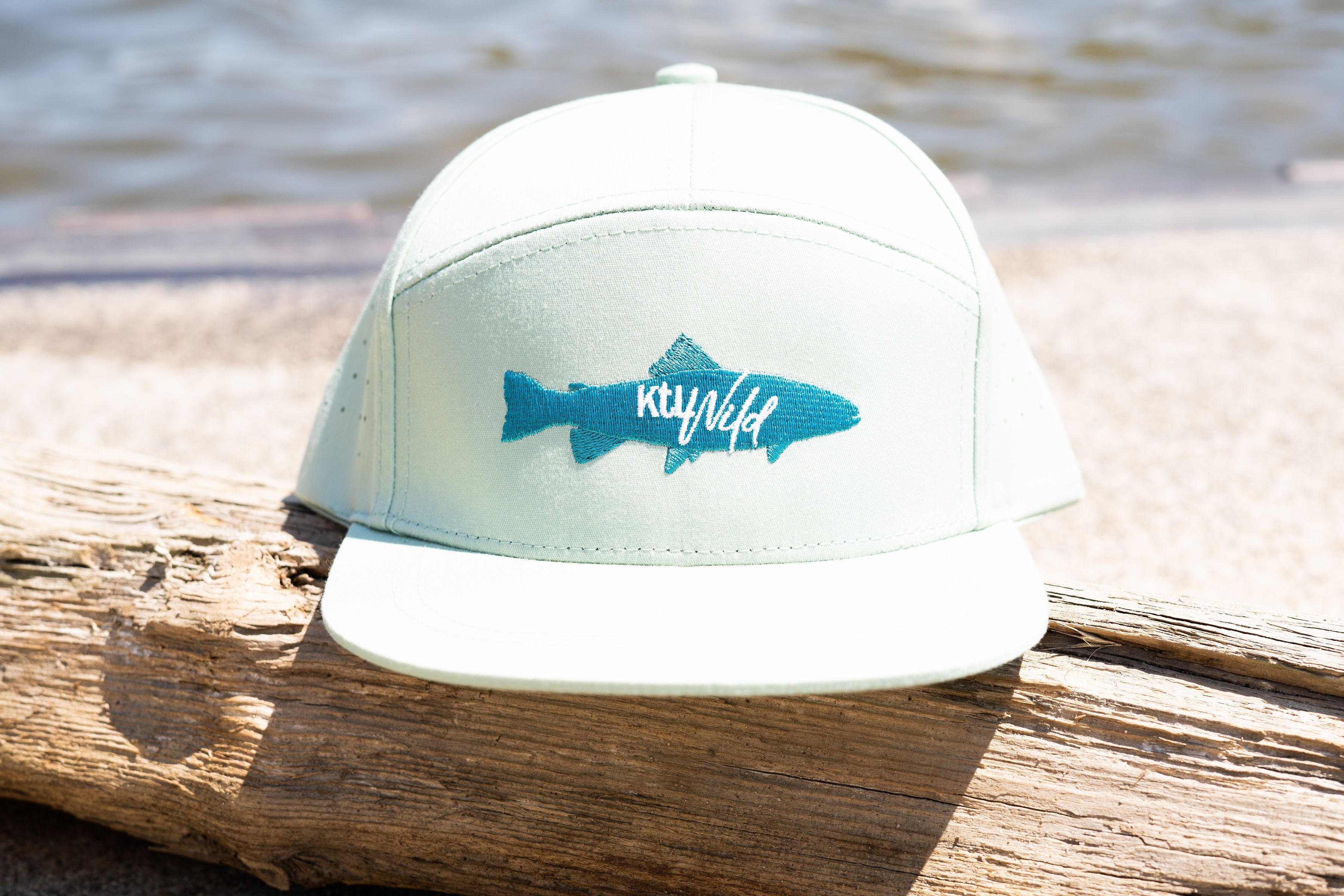 Keep the Littles Wild snapback cap with "The Catch" design, featuring a black and white embroidered logo on the front.