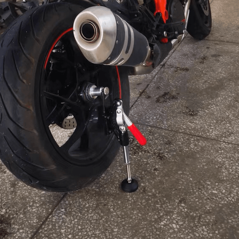 Bean's Moto Booth JSAMAE™ portable motorcycle lift jack shown in use, elevating a motorcycle for maintenance or repair.