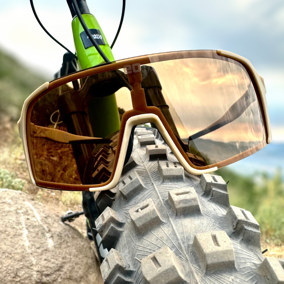 Eastern Outer Uno Mas Photochromic+ sunglasses with khaki frames and tinted lenses, shown outdoors in natural light.