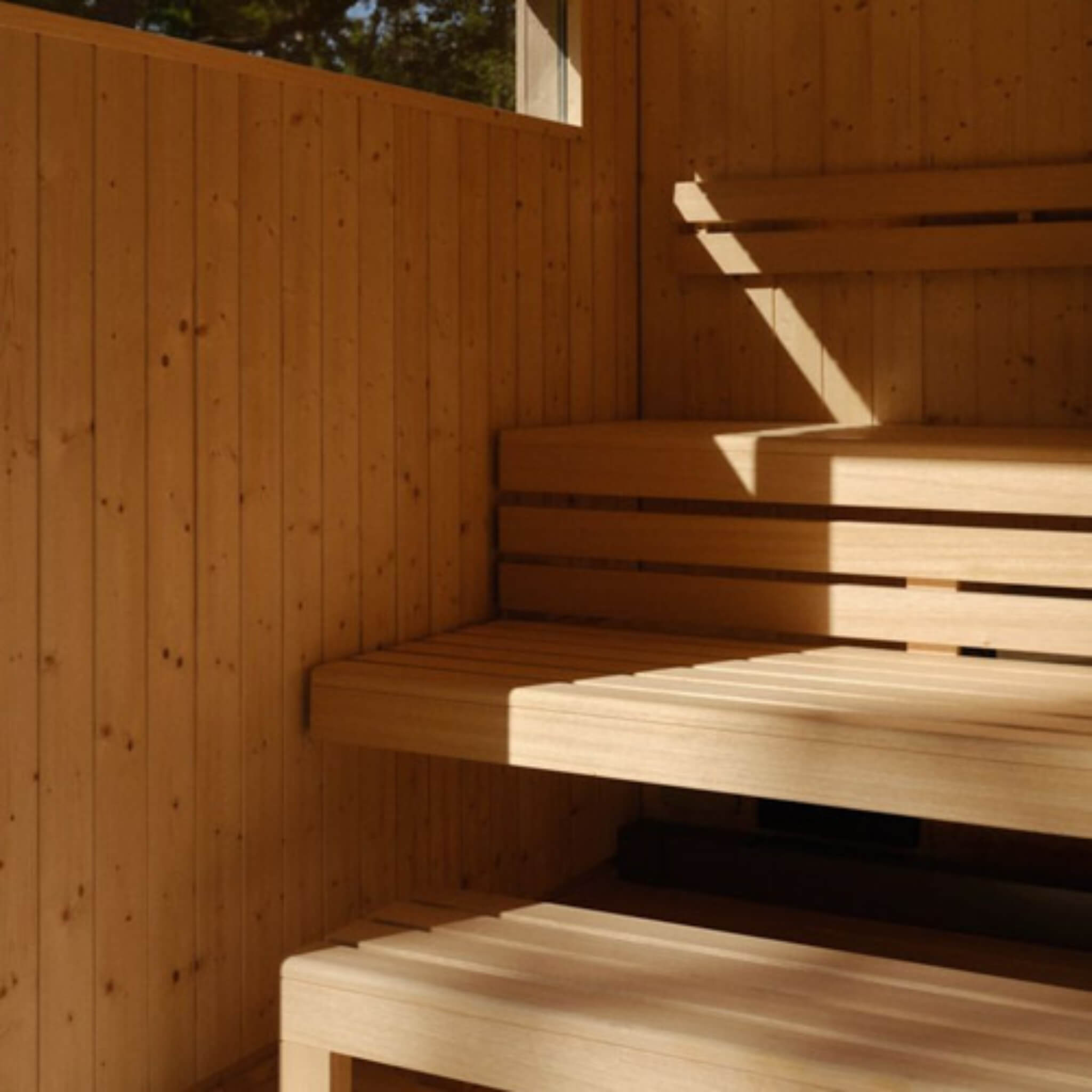 Kohler C2 outdoor gray spruce sauna kit for 3 to 6 people, showcasing wood structure and design features.