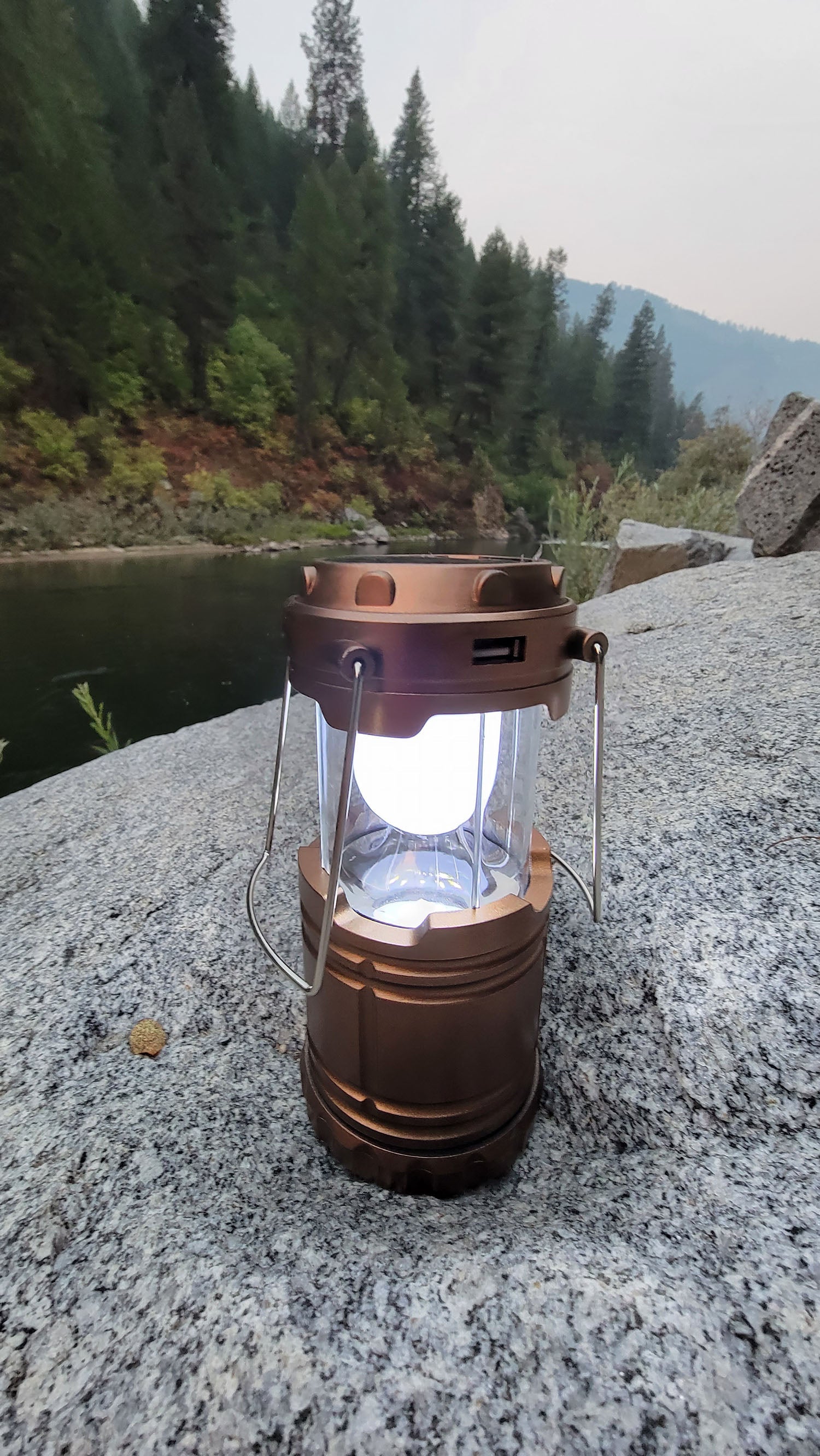 Collapsible solar camping lantern with rechargeable LED light, ideal for backpacking, camping, and emergency lighting.