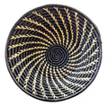 Large black and white woven African basket by Reflektion Design, showcasing intricate woven patterns and textured surface.
