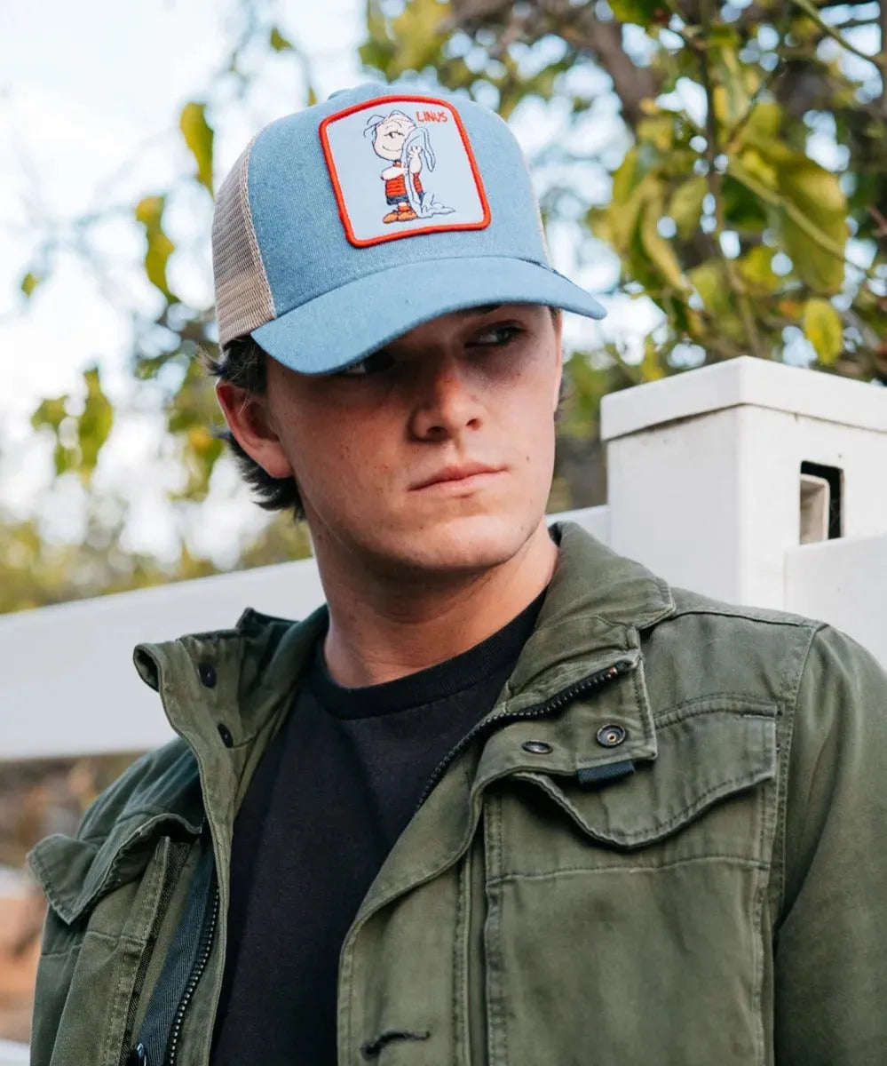 Peter Grimm Peanuts Linus denim trucker cap featuring embroidered Peanuts character and adjustable mesh back.