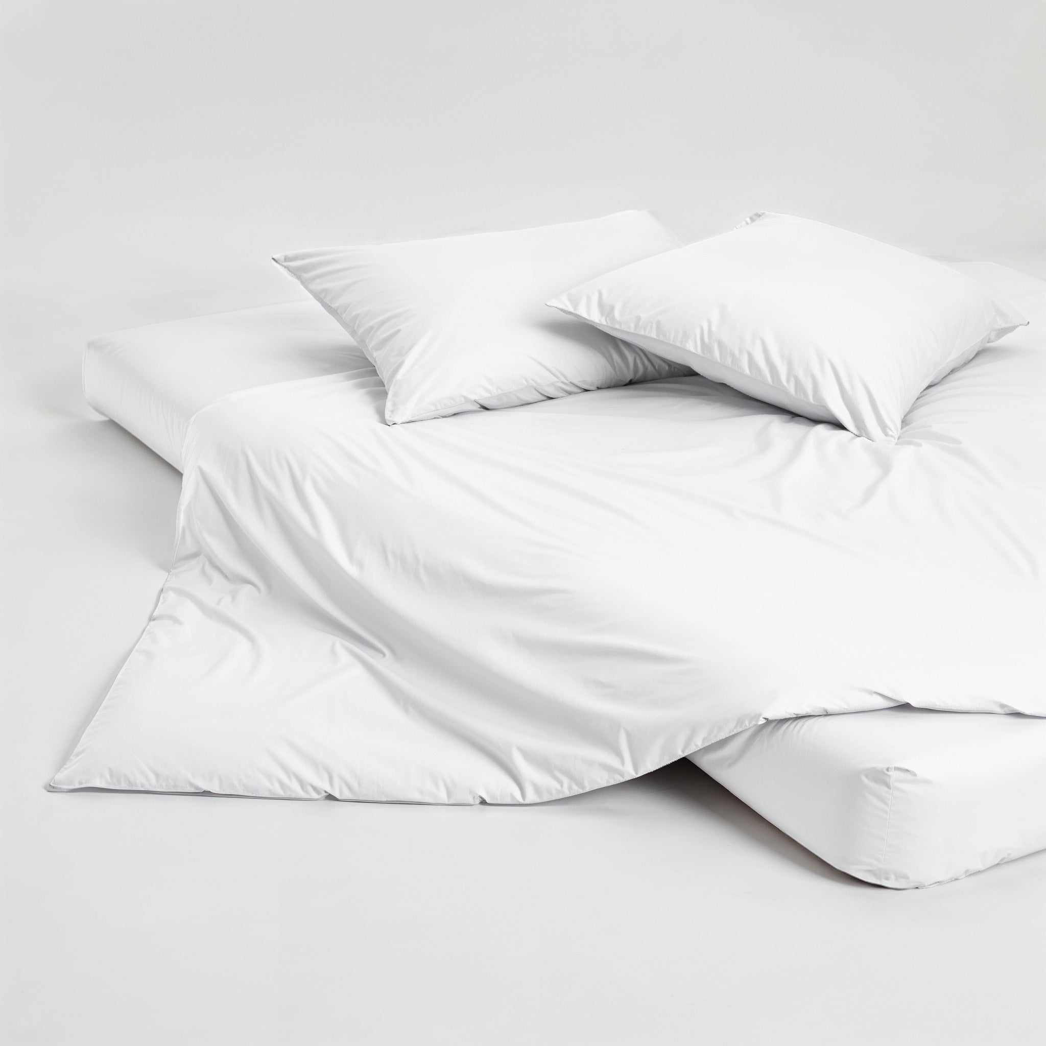 White Luxe Australian Sateen duvet cover from Italic with button closure, showcasing smooth, luxurious fabric on a bed.