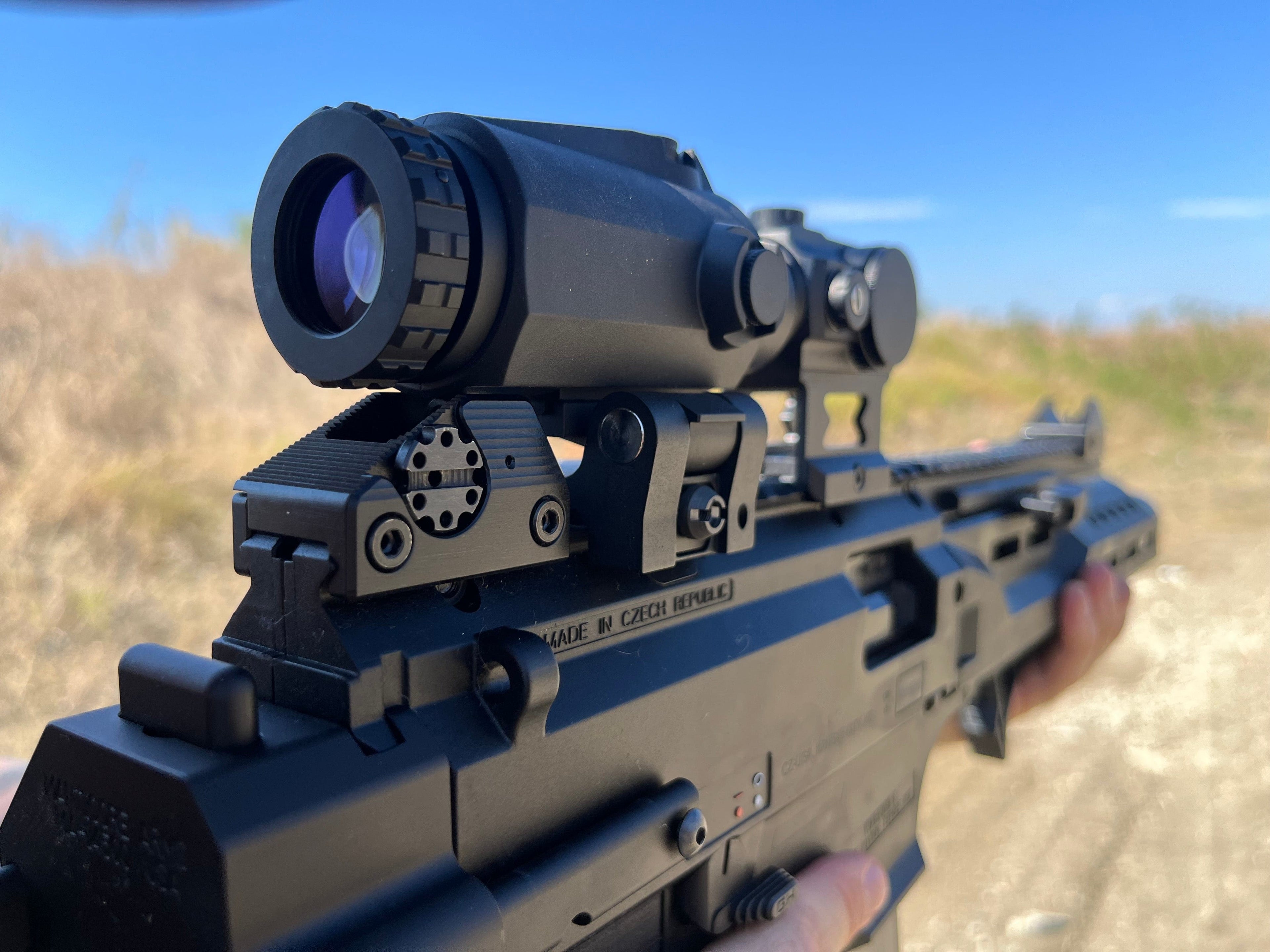 SFT2 Tactical Dragoon 3x Magnifier used with rifle optics, featuring a clear lens and tactical design for improved aiming accuracy