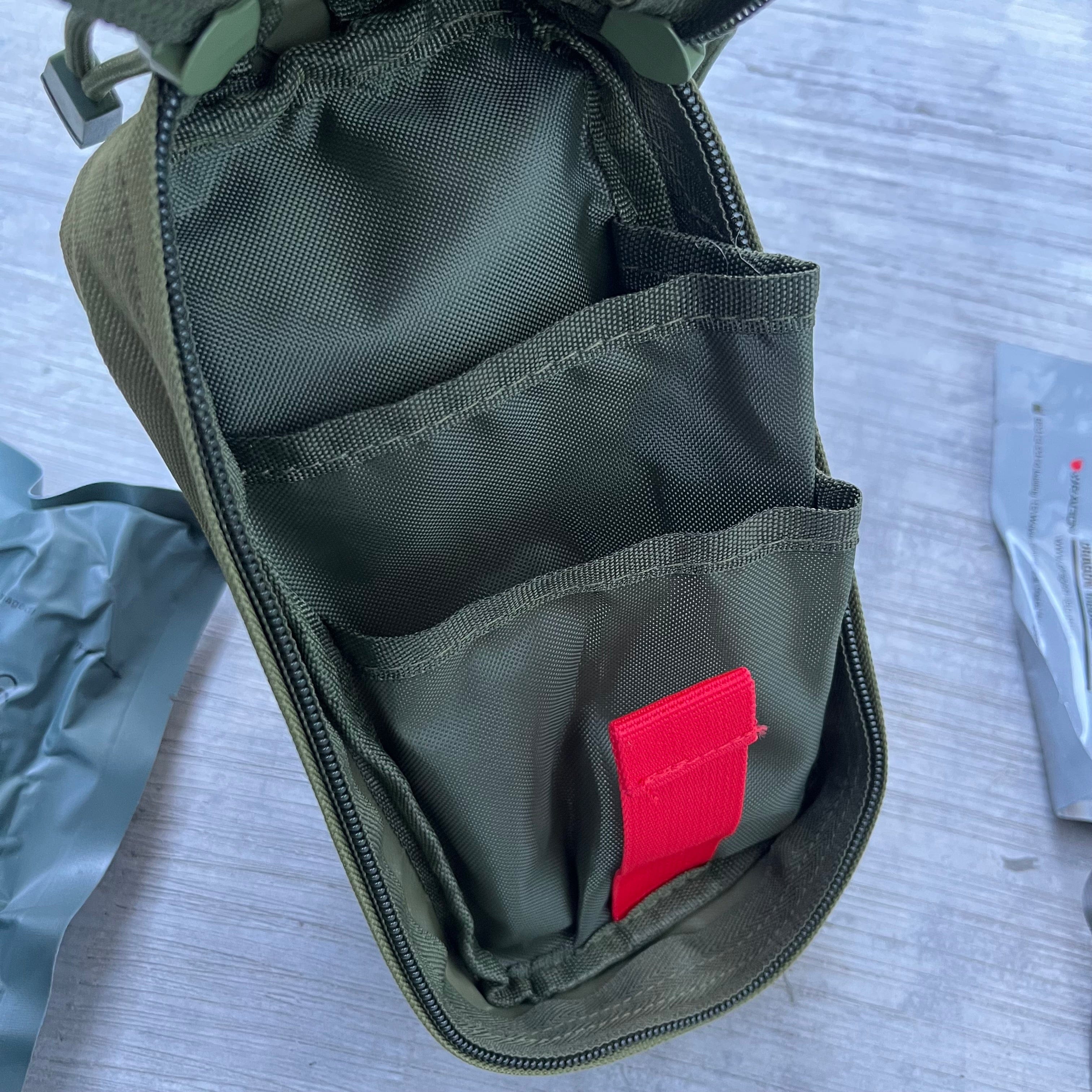 SFT2 Tactical essential IFAK medical supplies bag in a compact design, suitable for first aid storage and transport.