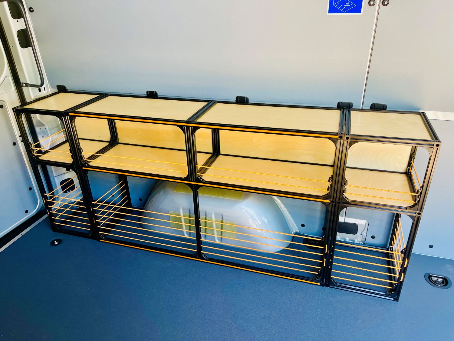 Mercedes Sprinter 144 camper van conversion shelving set by TNTvans with orange finish, ideal for DIY van build storage.