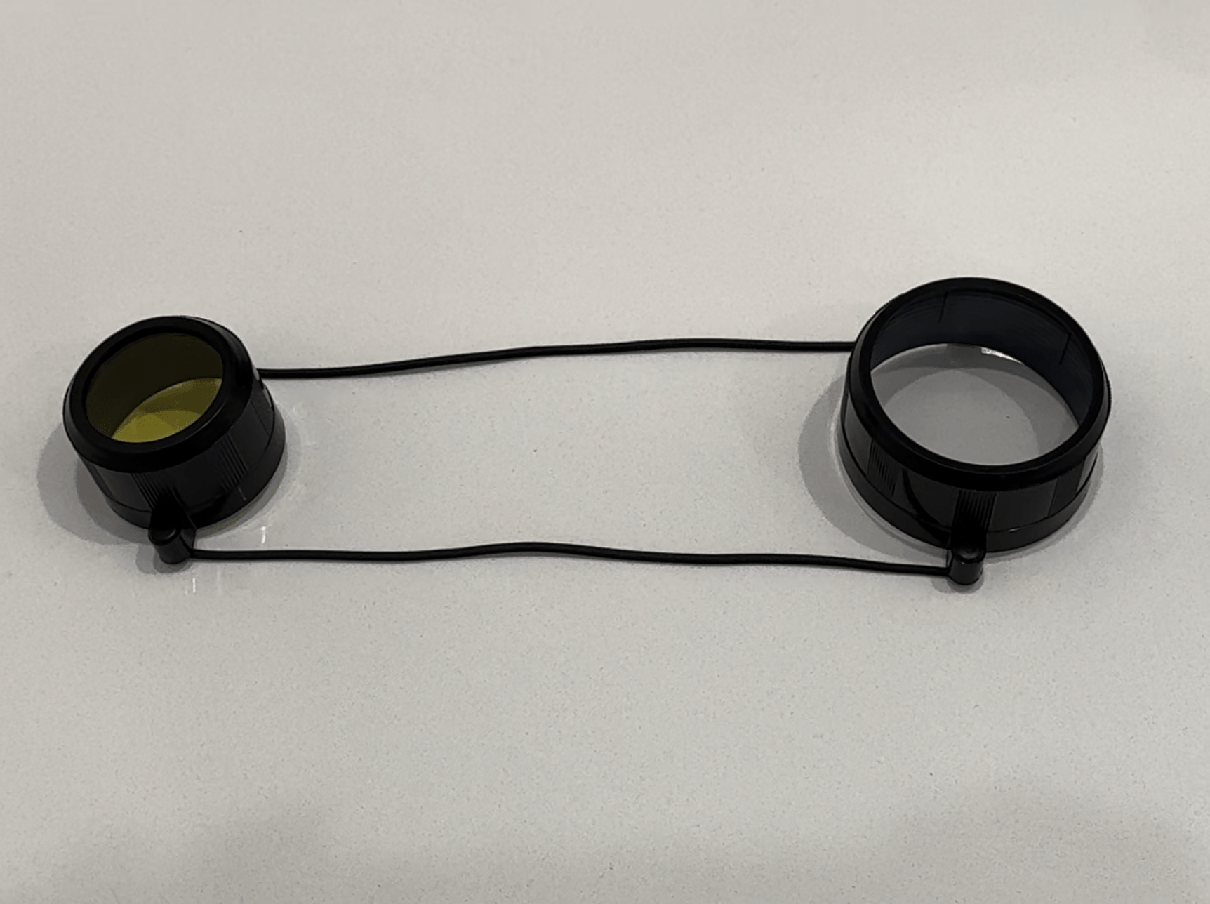 SFT2 Tactical Lens Cover in black, designed to protect tactical lenses from dust and scratches.