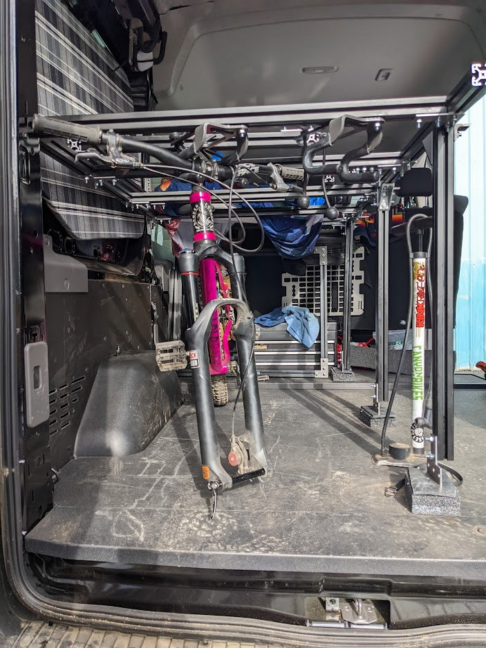 Lolo Racks L-track compatible single bike carrier as a DIY rack accessory, shown with mounting components and hardware.